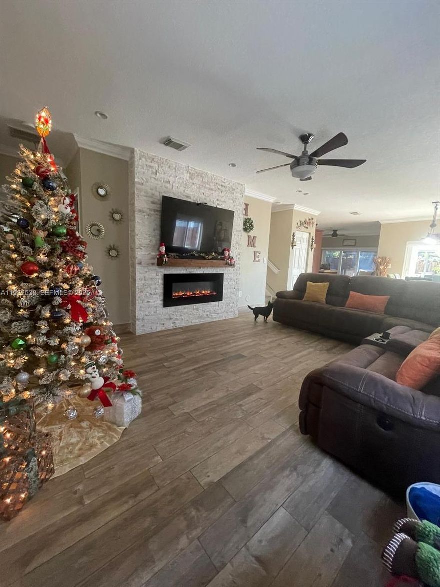 Beautifully maintained single-family home featuring 5 bedrooms and 3 full bathrooms, including one bedroom and one full bathroom on the first floor, ideal for guests or multi-generational living.
This home offers a double garage, spacious living and dining areas, and a stylish electric fireplace. The open eat-in kitchen flows seamlessly into the family room, creating a perfect space for everyday living and entertaining. The property features impact doors and windows throughout and a new roof installed in 2019. 
The second floor includes a spacious primary suite with a double shower and walk-in closet, plus three additional bedrooms and a convenient second-floor laundry room.  Enjoy the backyard with barbecue area, perfect for gatherings and relaxation.  Residents have access to a resort-style clubhouse offering a gym, picnic area, kids’ pool, jacuzzi, sauna, and ballroom—ideal for hosting special events.   Conveniently located near Baptist Hospital, Homestead Speedway, Key Largo, outlet malls, shopping centers, supermarkets, and a wide variety of outdoor activities. Don’t miss the opportunity to own this spectacular property with a very low HOA!