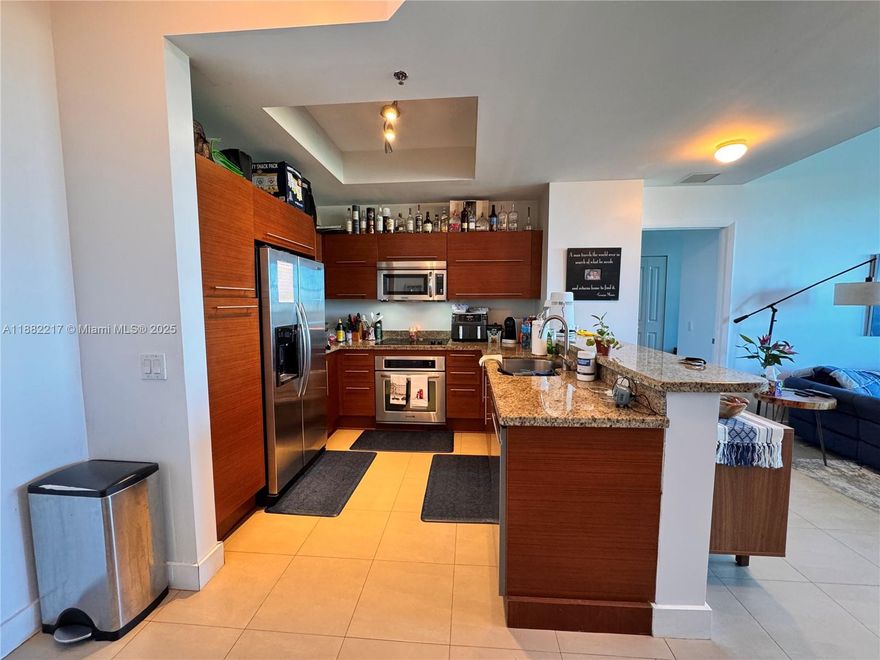 SPECTACULAR PENTHOUSE at TAO SAWGRASS! This elegant 2 bed / 2 bath residence soars with soaring higher ceilings, creating a bright and spacious atmosphere. Features include tile floors in living areas and rich wood floors in bedrooms, modern window treatments, and a private balcony with breathtaking panoramic views of the lake, pool, and Everglades sunsets. The kitchen boasts granite countertops, stainless steel appliances, and ample storage. The master suite offers a spa-style bath with Roman tub and dual sinks plus large walk-in closets with built-ins. This rare penthouse includes 2 covered parking spaces and an additional storage room. Enjoy resort-style amenities: pool, tennis, gym, clubhouse, 24-hour security. Walking distance to Sawgrass Mills, dining, and easy access to highways.