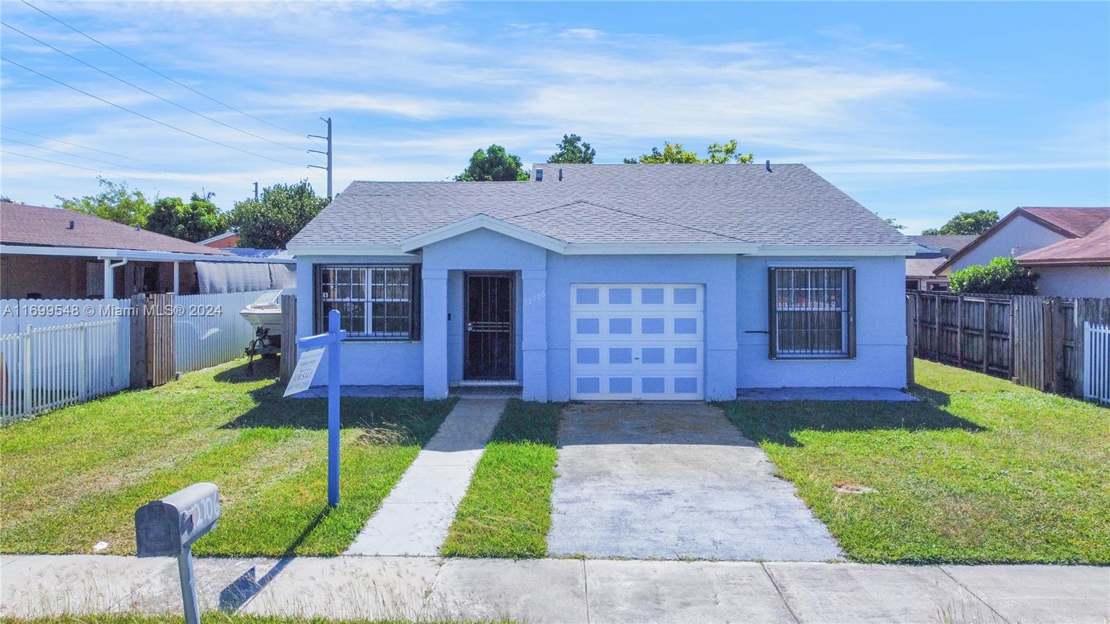 Welcome to this stunning 3-bedroom, 2-bathroom home with a one-car garage, ideally located near the Florida Turnpike and Air Reserve Park. The home features a NEW ROOF installed in 2019 and a practical split floor plan with beautiful ceramic tile throughout. The spacious master suite offers a large walk-in closet, and both bathrooms have been tastefully updated. Enjoy the huge screened porch and expansive backyard perfect for entertaining or relaxing, with ample room to store your boat in the fenced yard. The updated kitchen includes sleek Samsung stainless steel appliances, including a washer and dryer, all purchased in 2019. Additional updates include a new A/C system (2019) and a new water heater (2022). Accordion shutters on all windows provide added peace of mind.