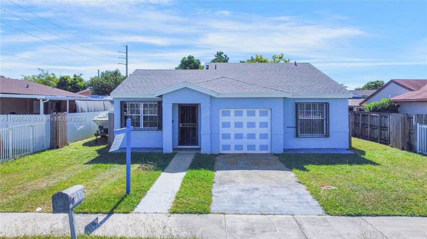 Welcome to this stunning 3-bedroom, 2-bathroom home with a one-car garage, ideally located near the Florida Turnpike and Air Reserve Park. The home features a NEW ROOF installed in 2019 and a practical split floor plan with beautiful ceramic tile throughout. The spacious master suite offers a large walk-in closet, and both bathrooms have been tastefully updated. Enjoy the huge screened porch and expansive backyard perfect for entertaining or relaxing, with ample room to store your boat in the fenced yard. The updated kitchen includes sleek Samsung stainless steel appliances, including a washer and dryer, all purchased in 2019. Additional updates include a new A/C system (2019) and a new water heater (2022). Accordion shutters on all windows provide added peace of mind.