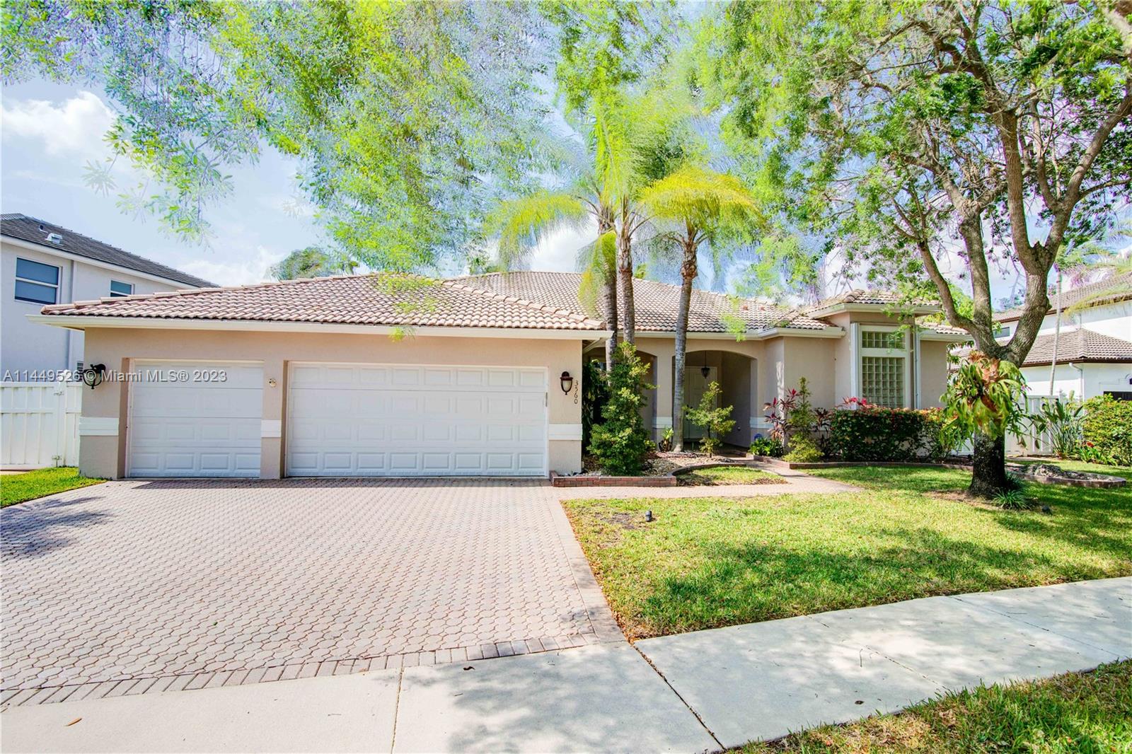 Amazing 4 Bed/3 Bath home located in the gated community of Windsor Palms. Enjoy beautiful lake views, heated swimming pool in a fenced backyard with 2 mango trees. One of the baths is connected to the pool patio. Primary Bath has dual vanities and sinks, bidet, separate tub and shower. This home includes a full house generator, solar panels to heat the pool and home theater system installed in family room. One room converted into home office with floor to ceiling wood bookcase. Stainless steel kitchen appliances (double oven) and granite counter tops, ceramic tile through out the home. 3 car garage, the doors replaced in 2023, Accordion shutters, Electric Porch Awning, Water Heater in 2020, Plumbing replaced in the home 2022.