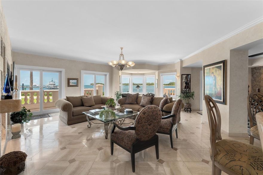 This ground-floor unit in Bayside Village offers 4BR/3.5BA, & 3,192 SF of living space with marble floors & sweeping views of the Atlantic Ocean, Fisher Marina, Virginia Key, Biscayne Bay, & Downtown Miami skyline. A wraparound terrace features covered seating areas, alfresco dining & direct access to the walking/golf cart path. An elegant entry foyer opens to a spacious living room w/bay window & seating area, faux fireplace, a private dining room, marble wet bar, chef’s kitchen w/top-tier appliances and a breakfast area. The principal suite includes dual walk-in closets, direct terrace access, and a spa-style bath with soaking tub & glass shower. 2 other BRs with en-suite baths, walk-in closets & terrace access. The spacious 4th BR can be accessed from the front terrace of the unit.