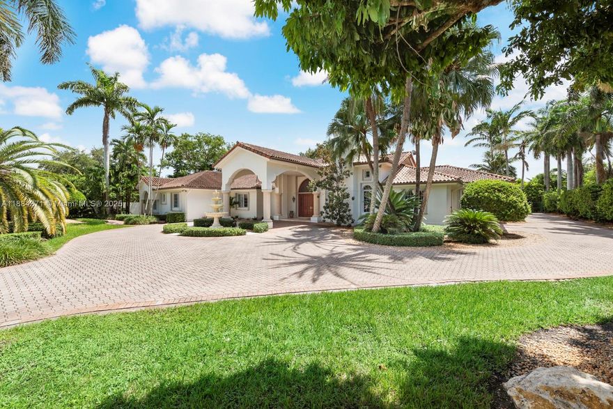 Set on over an acre in Miami’s Sunset neighborhood, this gated ranch-style estate by Cuban architect Raymond Pacheco is offered for the first time after three decades of family ownership. Spanning 9,000+ sqft on a single level, the home features three distinct sections with private entrances: a 4BR/3BA main area, a 2BR/1BA secondary area, and a detached 1BR studio—ideal for multi-generational living. Interiors boast 17 ft ceilings, expansive windows, and rich wood finishes. The kitchen, dining, and family rooms open to a vast covered patio, perfect for entertaining. Outdoors, enjoy two courtyards, a pond, walking path, tiki hut with outdoor kitchen, three-car garage, and lush landscaped grounds. Minutes from Coral Gables, South Miami, and top rated public and private schools.