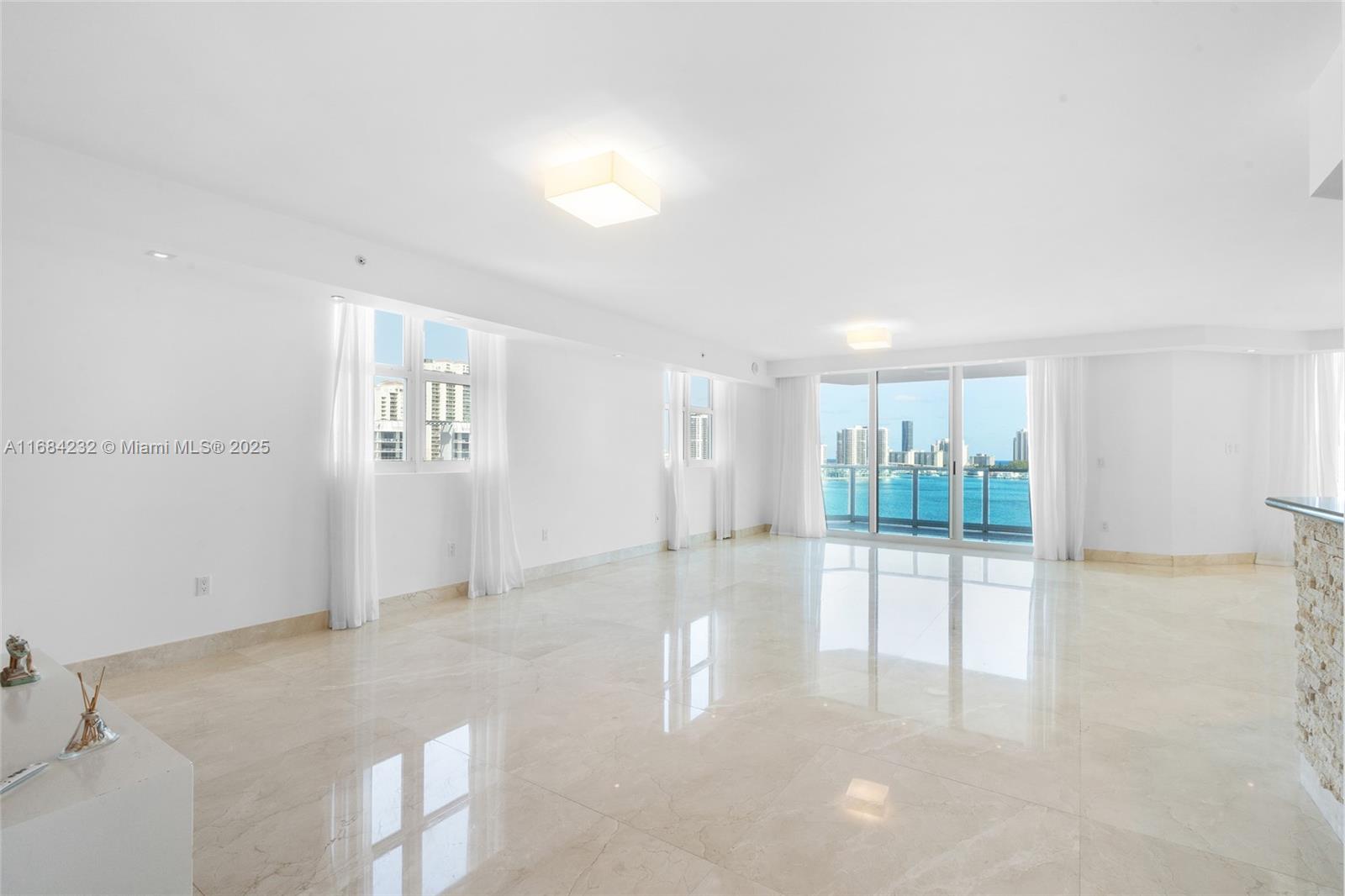 Perfect place to call home! Corner apartment filled with natural light and super spacious, best line in the building! Featuring customs closets, dropped ceiling with recessed lighting, automated window treatment, open kitchen, large marble floor and spectacular view of the intercostal! Must see to appreciate. The apartment is flow through facing east and west. Comes with a storage unit!