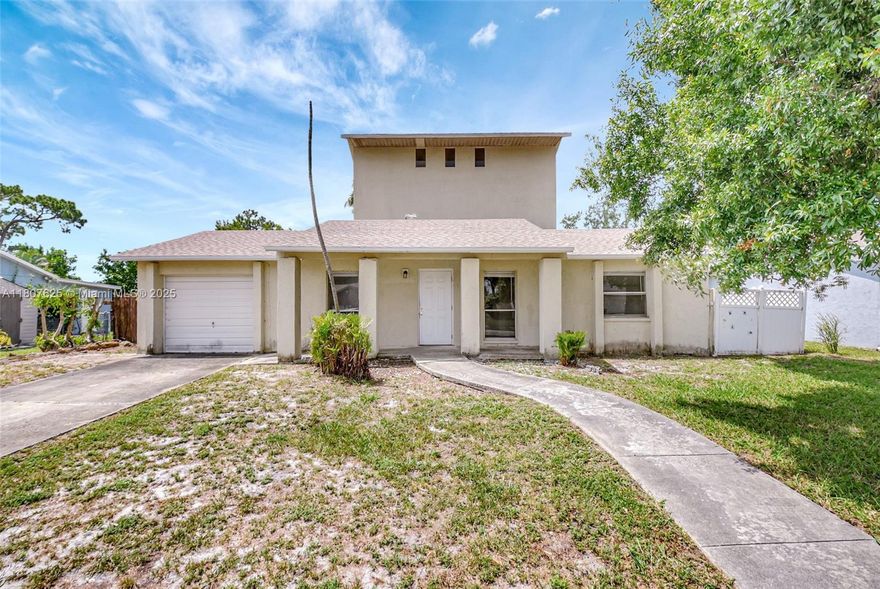 Two-story home situated on a 13,878-sq.ft. lot in a quiet neighborhood. The first floor features two bedrooms and one bathroom, while the second has two additional bedrooms and two bathrooms, offering a nice split floor plan. The roof was recently replaced in November 2024. The kitchen has wood cabinets and granite countertops, while the bright and spacious Florida room provides ample natural light. The fenced backyard offers plenty of space for a boat, RV, or pool. This home is ideally located, providing easy access to major roads such as Southern Boulevard and the Turnpike, as well as PBI Airport, City Place, and the Kravis Center. Grocery stores, schools, and Palm West Hospital are just minutes away, and the beach is less than a 20-minute drive.