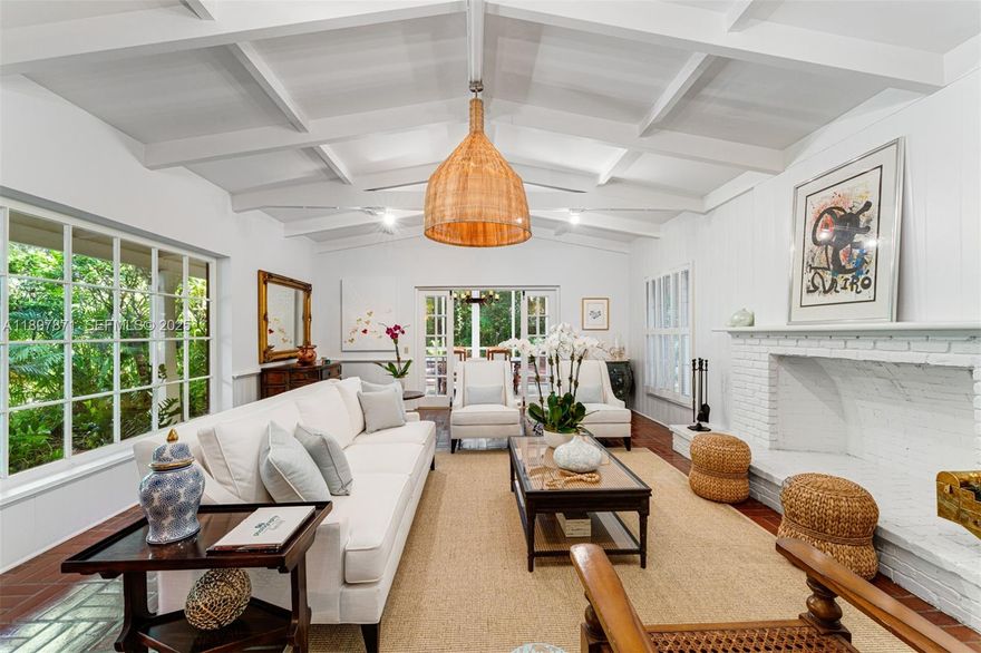 Secluded and full of charm, this unique two-story home sits on an expansive 54,450 sq ft wooded lot, offering privacy and endless potential. Featuring 4 bedrooms and 3 baths, including a first-floor primary suite, the home boasts vaulted ceilings, timeless Chicago brick accents, and a cozy wood-burning fireplace. A glass-enclosed patio dining area fills the space with natural light, perfect for relaxing or entertaining. Surrounded by mature trees and nature, enjoy the peaceful setting complete with a koi pond. Located near excellent schools, this property is ideal to live in or to build your dream home on this beautiful, private lot.