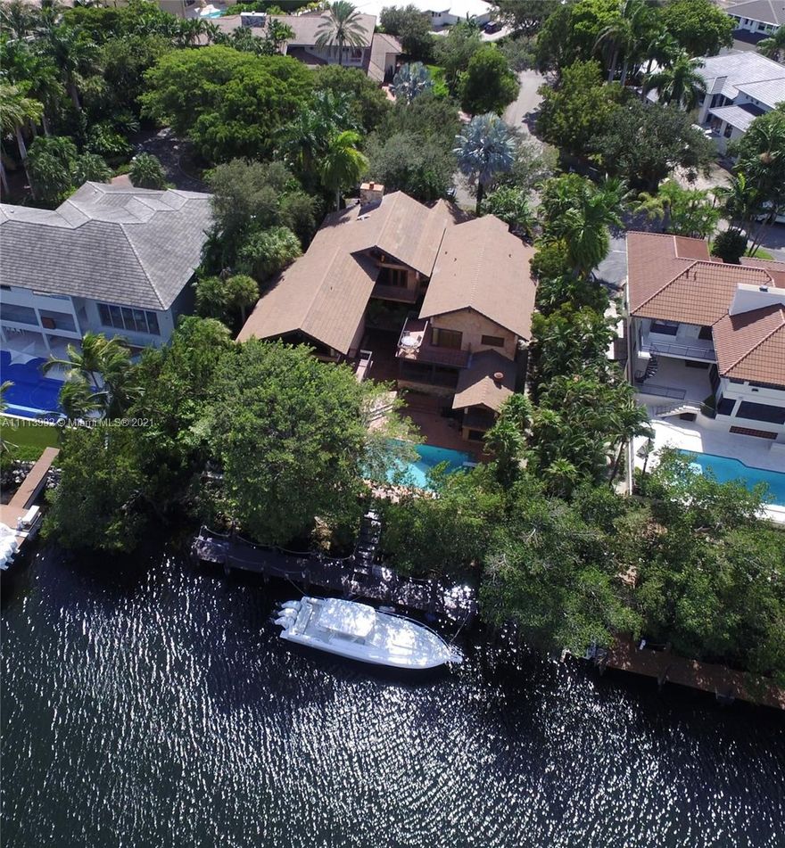 Yachtsman's dream home with 100 feet of waterfront, complete with wood dock and NO bridge to bay. Enter into a light filled living area with high ceilings.  Enjoy an updated Chef's kitchen with top of the line appliances and brand new summer kitchen. Large master suite has private balcony that looks over pool and waterway, spa like bath and walk in closet with custom cabinetry. 3 additional bedrooms and 2 baths on 2nd level. Lower level has gym, wine cellar, large living area with wet bar and 2 additional bedrooms.  Enjoy all the amenities the coveted gated community of Cocoplum offers.