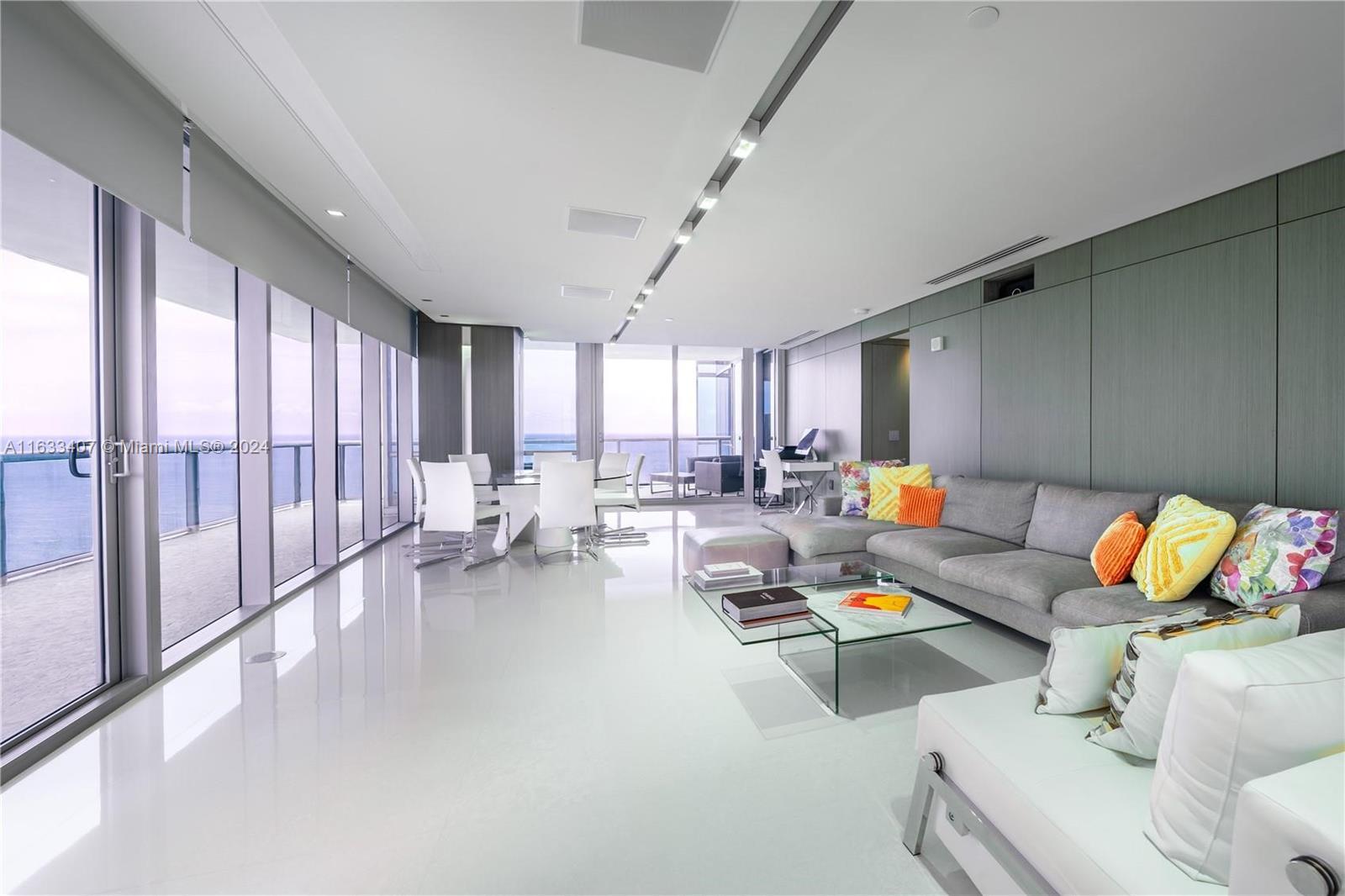 Spectacular 4 Bedroom Corner Unit at Jade Ocean. This rarely available 2,485 sq ft unit offers stunningly appointed, contemporary corner residence on the upper levels of Jade Ocean. Professionally designed, the interior boasts genuine Quartz flooring and white oak-wood bedrooms, extensive wood paneling, Kreon lighting, snap-glass in the master bathroom, and river rock flooring on the terraces. Crestron smart home system, complete with HD roll-down theater projection in the living room and automated window shades. High-quality finishes throughout. Jade Ocean features remarkable amenities, including two pools, expansive fitness and spa facilities, and a cinema.