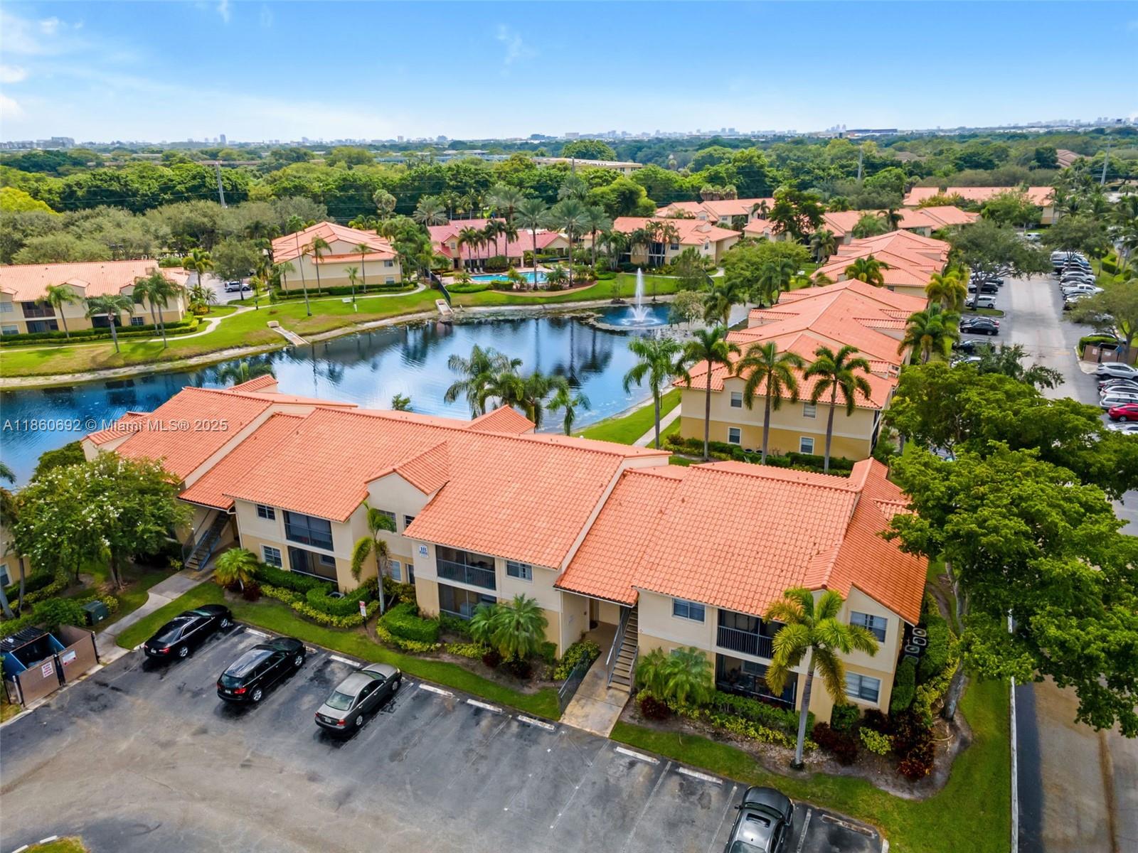 Beautifully updated 2BR/1BA condo in the gated Royal Poinciana community! This first-floor corner unit offers a private patio with storage and stunning lake views. The open kitchen features granite countertops, stainless steel appliances, a pantry, and in-unit washer/dryer. The newly renovated bathroom includes dual sinks, modern vanities, and a tiled shower. Tile floors throughout. Enjoy resort-style amenities—pool, tennis courts, gym, dog park, and car wash. HOA includes water and lawn care. Assigned parking plus ample guest spaces. Fantastic location close to shopping, dining, and major highways! Great for investors as it can be rented right away.