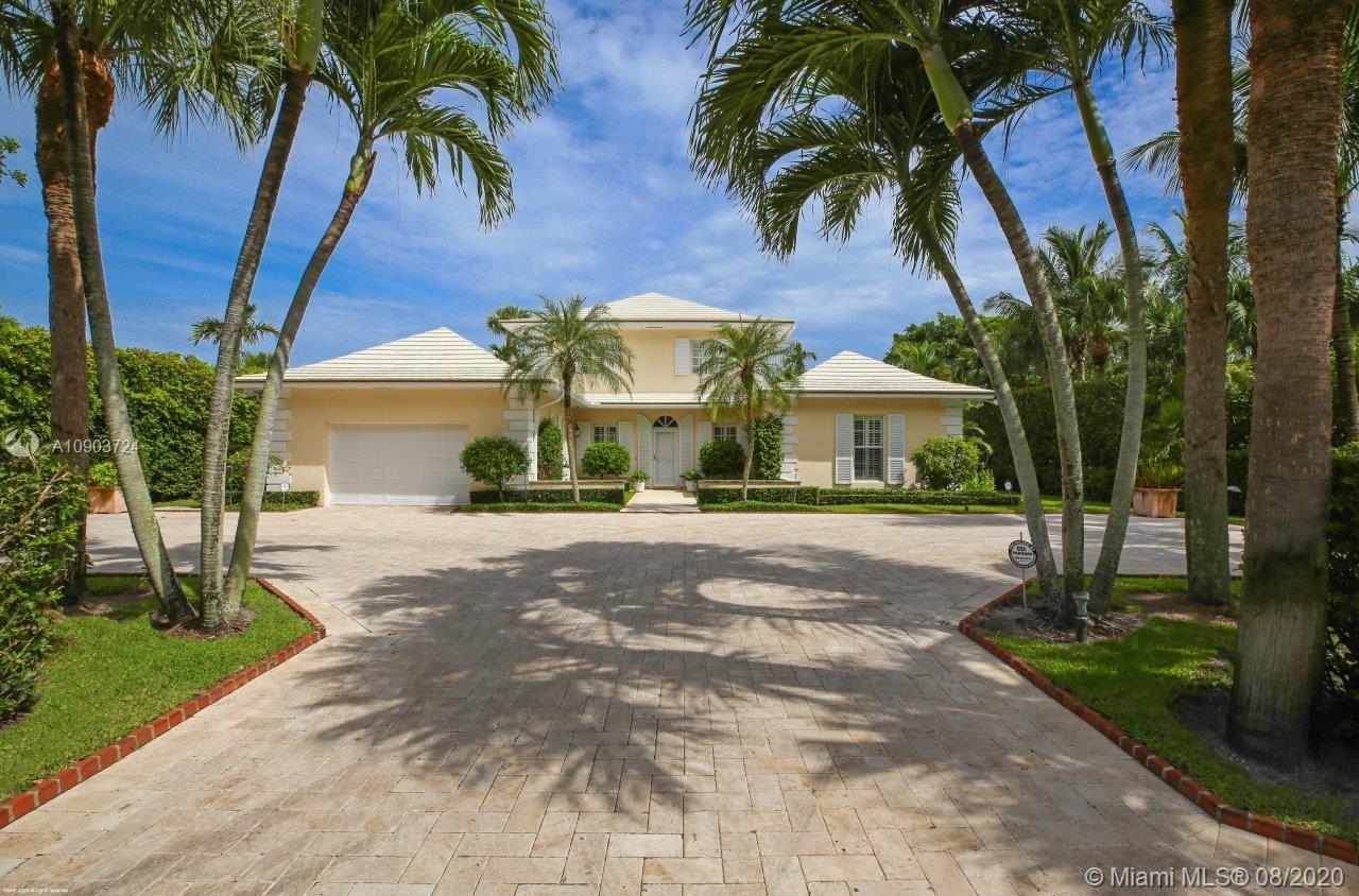 This impeccably maintained 2-story Bermuda style residence is privately located in the heart of Jupiter Island. Step into its spacious living room featuring a high coffered ceiling, built-in bar and a wall of elaborately handcrafted display shelves. The living room nicely blends into the dining area with a hand-painted trompe-l'oeil ceiling. A manicured garden setting surrounds the impressive patio area with an inviting heated pool. The kitchen features a center island, white cabinetry, stainless steel appliances and sparkling marble countertops. There are 3 bedrooms downstairs including the master suite with "His" and "Her" bathrooms and walk-in closets and 2 guest bedrooms with ensuite baths.