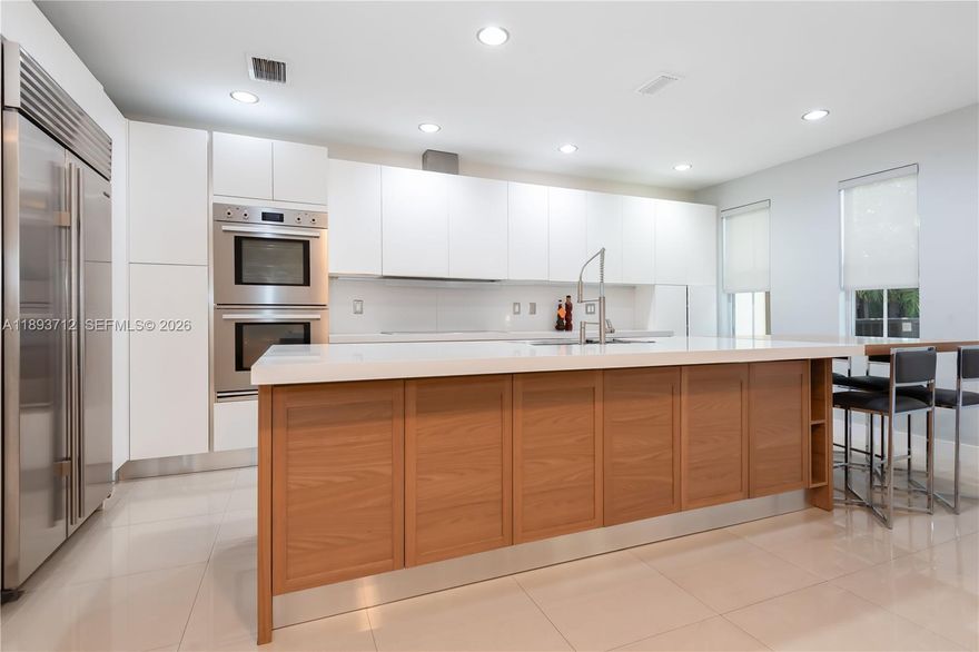Completely renovated townhome in The Reserve at Doral East. Contemporary design with modern finishes and 10-ft ceilings; tile flooring on the first floor and original hardwood upstairs. Italian-style kitchen with quartz countertop and wood island extension, high-end appliances including double ovens and wine cooler. Impact windows and doors throughout, Trane A/C, LED lighting, electric blinds, and private balconies. Community includes a clubhouse with pool, gym, Wi-Fi room, playground, and 24-hour gated surveillance. Three assigned parking spaces plus guest parking.