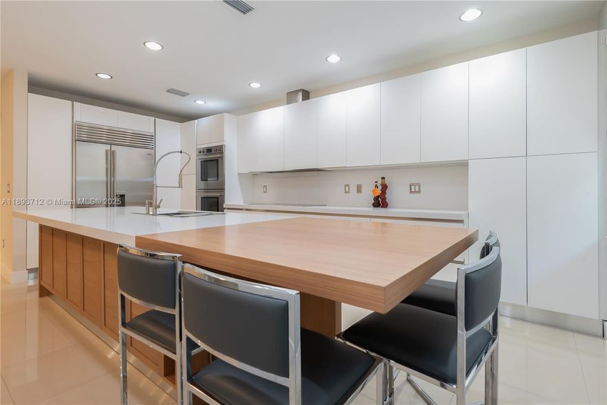 Completely renovated townhome in The Reserve at Doral East. Contemporary design with modern finishes and 10-ft ceilings; tile flooring on the first floor and original hardwood upstairs. Italian-style kitchen with quartz countertop and wood island extension, high-end appliances including double ovens and wine cooler. Impact windows and doors throughout, Trane A/C, LED lighting, electric blinds, and private balconies. Community includes a clubhouse with pool, gym, Wi-Fi room, playground, and 24-hour gated surveillance. Three assigned parking spaces plus guest parking.
