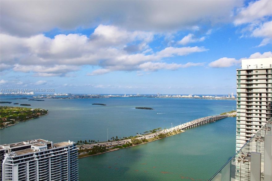 WATERVIEW UNIT with an open-concept design! This stunning 1-bed, 1.5-bath condo features a sleek kitchen with quartz countertops, a metal subway backsplash, and top-of-the-line Bosch appliances. Perched on the 27th floor in the exclusive “BUBBLE,” it offers an extended balcony with upgraded designer tile, showcasing breathtaking views of Biscayne Bay and Miami Beach. The master bath stuns with a dual-sink quartz vanity and a unique double-shower design. Amenities include a rooftop glass-enclosed pool, a second pool, tennis courts, gym, spa, sauna, grand saloon, theater, billiards, and a kids’ playroom. Steps from the Design District & Michael Schwartz’s restaurant!