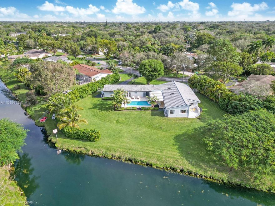 Immerse yourself in luxurious living with this extraordinary 4-bed, 3-bath house boasting a sparkling pool and captivating water view on a large canal. With a convenient in-law quarter complete with kitchenette and bright open space featuring a large gourmet kitchen this property combines practicality and elegance. The addition of a Tesla charger, exquisite landscaping, and its highly sought after location in a prestigious neighborhood with top rated schools make it an unparalleled gem. Don't hesitate, Seize the chance to own this remarkable and rarely available residence.