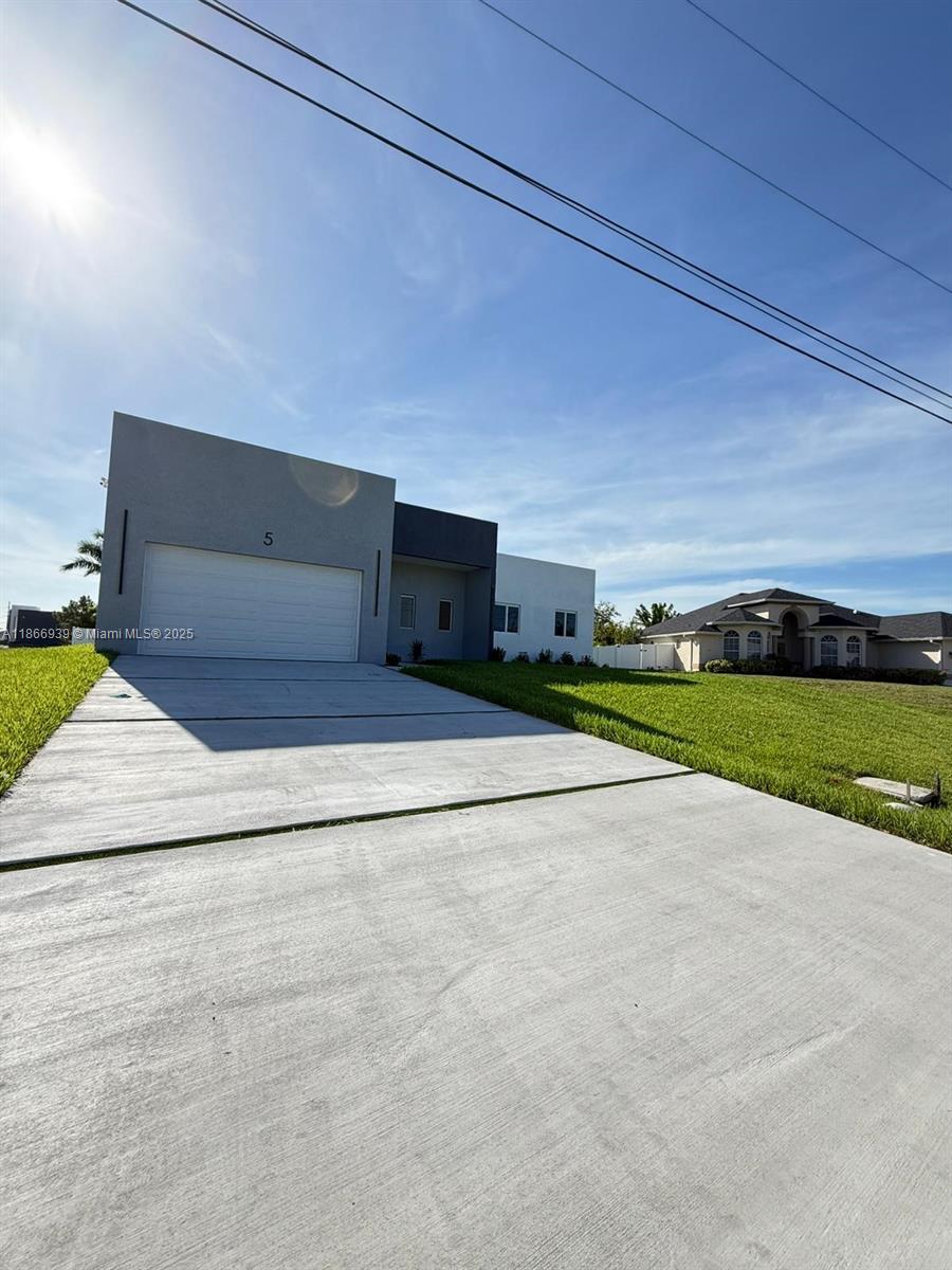 Stunning 3-Bedroom + Open Den Smart Home with sleek design Impact Windows / doors and high-end finishes. This modern layout offers tall ceilings, an open floor plan, amazing kitchen with Coffe / Bar station and a versatile den/office space. Smart features include Alexa system, smart switches, cameras, and Wi-Fi AC control. Chef-style kitchen with stainless steel appliances and Coffee Station, LED mirrors, and a dramatic 16-ft front entrance. Enjoy a outdoor bar/kitchen, ideal for entertaining. The flat roof and gutter system enhance the home’s contemporary style. A perfect blend of design, comfort and technology