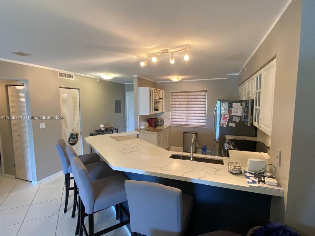 Photo of 2205 S Cypress Bend Dr #302, Pompano Beach, FL 33069 (MLS # A11623324)