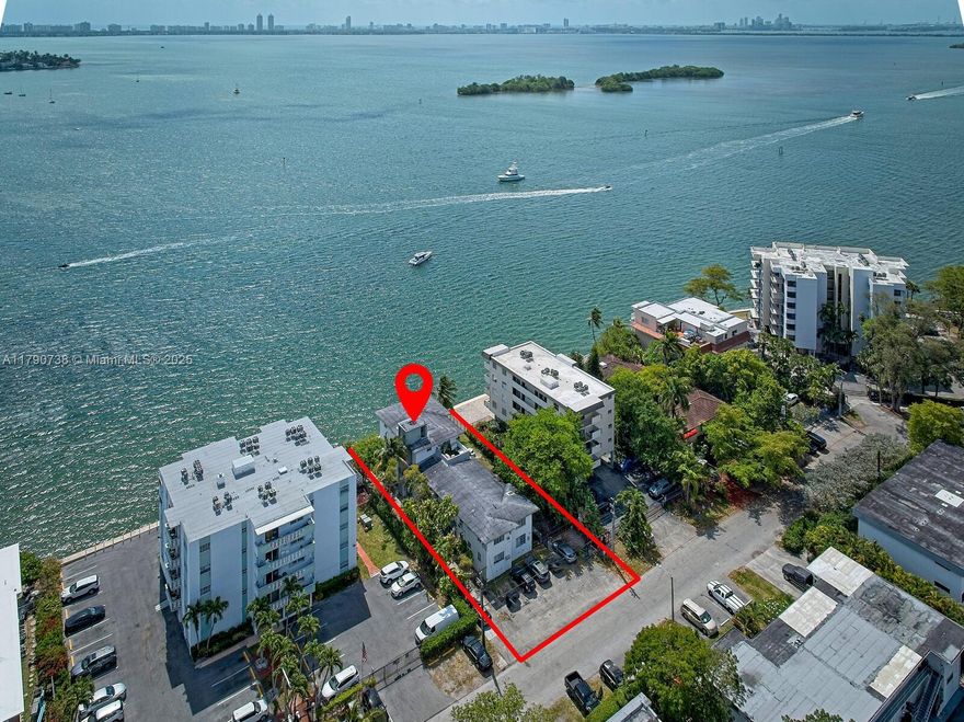 7805 NE Bayshore ct presents an incredibly rare opportunity to own and redevelop a prime bay front property just minutes from the Design District and Miami Beach. This is the only offering of its kind currently on the market in Miami. The existing structure is a 9 unit rental building, featuring eight 1 bedroom 1 bath units and one 2 bedroom 2 bath unit. According to City of Miami zoning (buyer to verify), the site allows for up to 30,605 square feet of residential living space, making it an ideal canvas for luxury development. Residents will enjoy unobstructed, first-class views of Biscayne Bay and Miami Beach. A brand-new seawall has already been completed, adding value and peace of mind for future development.
