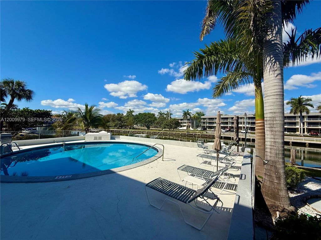 Photo of 467 Golden Isles Dr #310, Hallandale Beach, FL 33009 (MLS # A12009979)