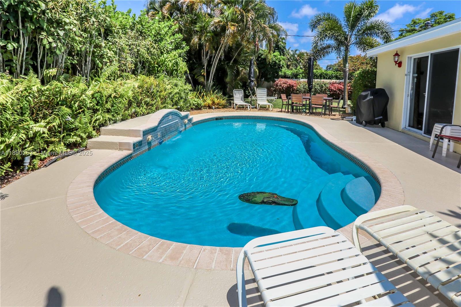 Beautiful 4-bed, 2-bath pool home in the heart of Wilton Manors! This spacious property features an open floorplan with abundant natural light streaming through large windows, creating a bright and warm ambiance. Set on an expansive 10,000+ sq ft corner lot, the fully fenced backyard offers resort-style living with a heated saltwater pool featuring a waterfall and landscaping lights. New Roof, New Gutters, New Water Heater, updated kitchen and baths, interior laundry room, impact windows in the Florida Room, and shutters for other windows add modern touches. A new sprinkler well pump is also included, and the home is being sold fully furnished. Currently holding an active vacation rental license, this property is ideally located near downtown Fort Lauderdale and the beaches.