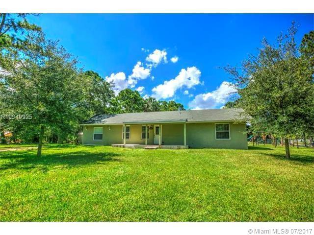 This stylish, contemporary home offers privacy and peaceful living in the upscale community of Jupiter Farms surrounded by multimillion dollar horse farms and Riverbend Park. Outdoor sports paradise, and only 8 miles from the best beaches. 5 miles from turnpike and 95. Completely remodeled 2015 with granite counters, marble on bathroom wall and back splash, and bamboo floors. It has a large open concept kitchen with split level island with cooktop and wall oven. All cabinets in kitchen and master bath are