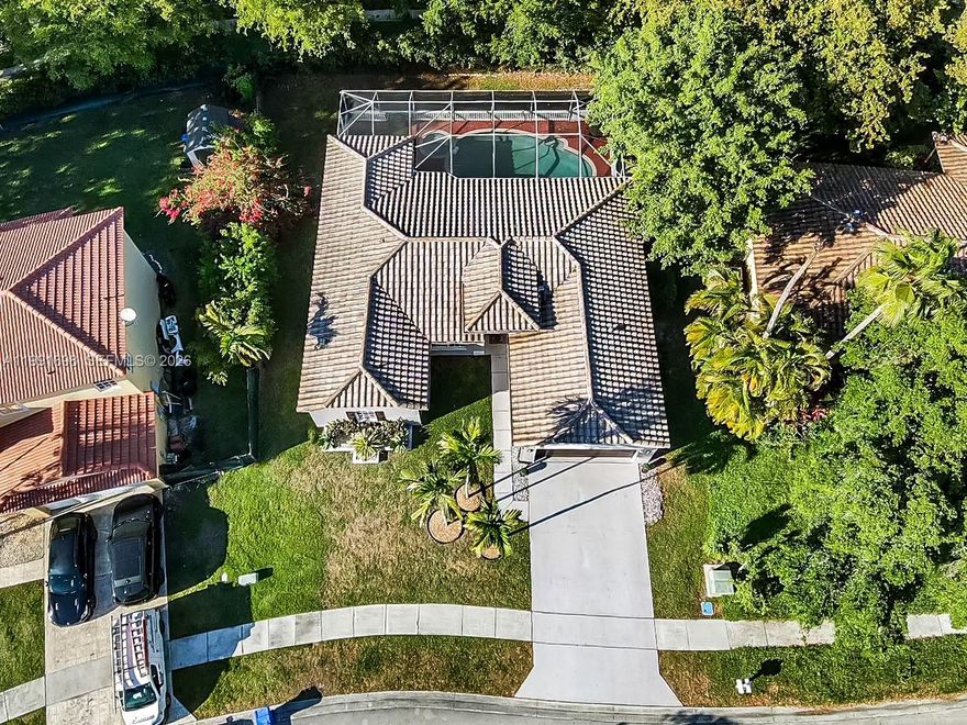 Welcome to this meticulously maintained single-family residence that seamlessly blends contemporary designer finishes with a private tropical sanctuary. Located at the heart of Miramar, this home immediately impresses with its exceptional curb appeal, featuring a 6 year old barrel tile roof, a wide concrete driveway, and an attached two-car garage with a modern dark-finish door. The home's exterior was recently painted in 2024. The front exterior is landscaped with towering mature palms and manicured greenery. The interior boasts an open-concept floor plan anchored by high-gloss tile flooring that flows throughout the primary living areas. The kitchen features granite counters and 4 year old stainless appliances. Primary bathroom and recessed lighting throughout were recently updated. New water-heater. The The formal living and dining spaces are elevated by sophisticated designer touches, including arched doorways, custom faux-greenery accent walls, and a striking spiral LED chandelier. Backyard features a screened inground pool and spa with complete privacy. A/C and air ducts were recently cleaned. Very low HOA. This one definitely wont last!