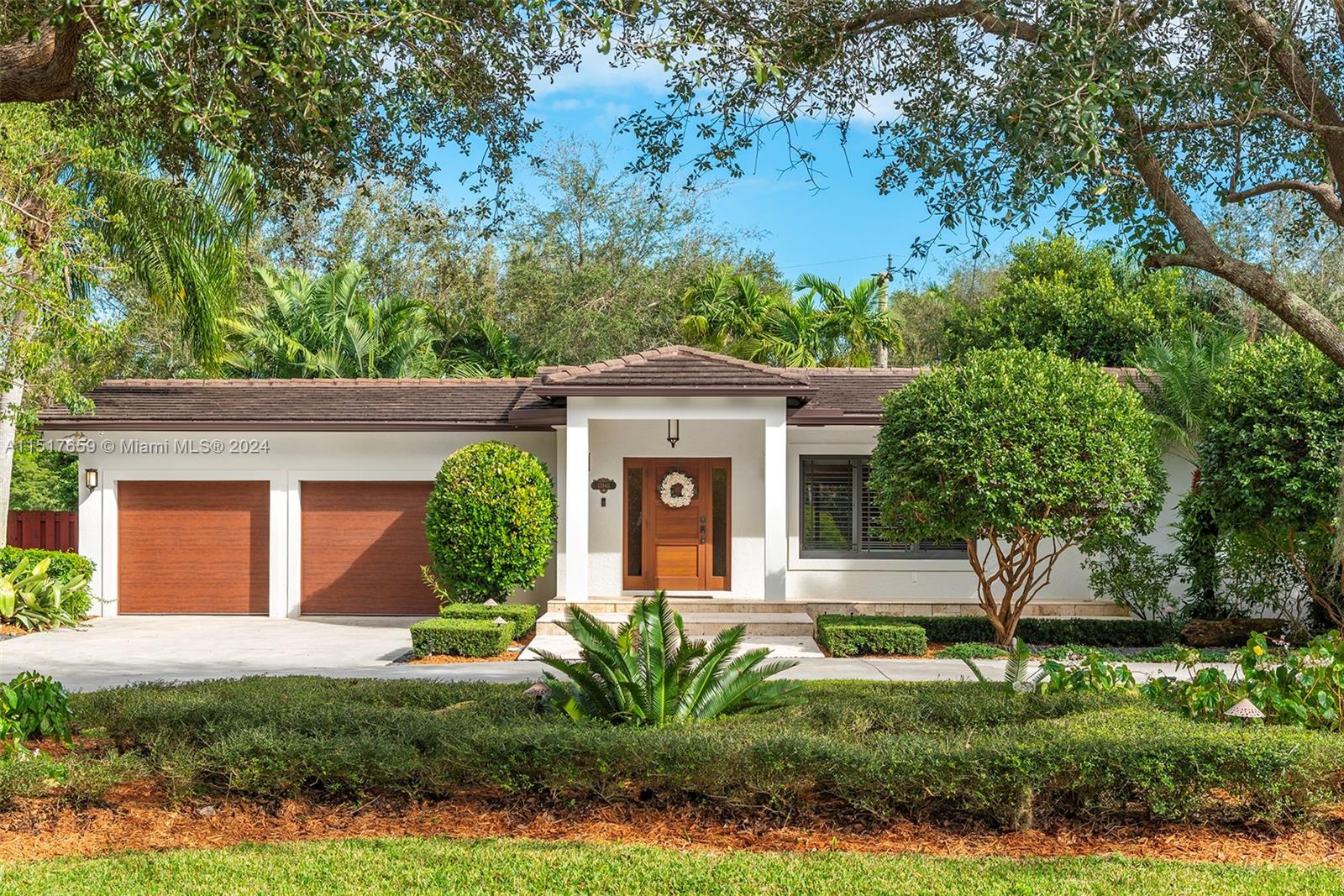 Set on an expansive builder’s acre on the border of Pinecrest and Palmetto Bay, 13945 Cartee Rd is meticulously updated and maintained. With a comfortable layout including 4 beds and 3 baths, the home offers numerous features including custom kitchen with inset cabinetry, expansive primary suite with 2 walk-in closets, indoor laundry/utility room, and a 2-car garage. Outside, a sweeping circular driveway welcomes guests beneath mature oak trees. Large sliding doors leads to backyard bliss featuring spacious side yards, an outdoor kitchen, covered dining, and a tempting pool with spa. Rear access on SW 68th Ave adds convenience for boat or trailer storage. Also enjoy peace of mind with complete impact windows/doors, flood zone X, and a 2016 roof. The best of South Florida living awaits!