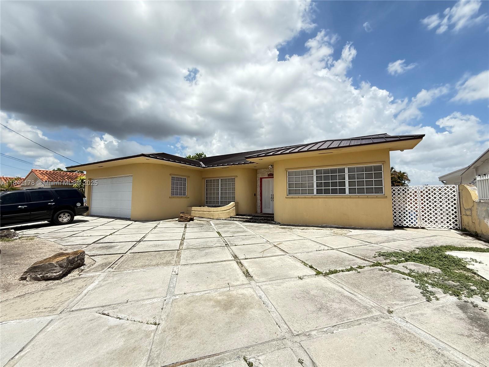 One-of-a-kind home in Hialeah with a layout you won’t find anywhere else on the block. From the moment you walk in, the tall ceilings, bold finishes, and two spiral staircases make a serious statement. This house is big, bright, and full of potential. The kitchen is decked out with glossy red cabinets, gas appliances, and a large island — perfect for entertaining. Bedrooms are spacious, bathrooms are updated, and the garage is massive — part of it is currently converted into a bedroom but can easily be returned to a full garage. Step out back to your private waterfront patio lined with palm trees — no rear neighbors. Whether you're ready to move in or make it your next project, this one’s got room to work with. No HOA. Easy to show!