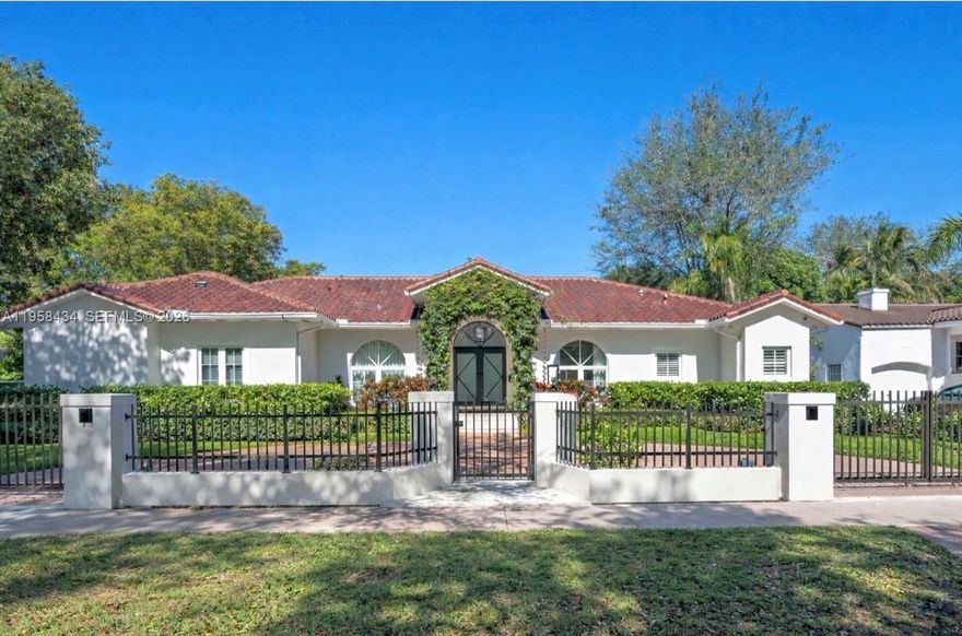 Situated on a prime corner lot along one of Coral Gables’ tree-lined avenues, this elegant, privately gated residence offers a refined blend of classic charm and modern upgrades. The home features high-impact windows and doors, a bright south-facing orientation, and a functional layout ideal for both everyday living and entertaining. The kitchen is equipped with Thermador appliances and custom cabinetry. Interior highlights include built-in cabinetry, washer and dryer, automatic garage door opener, and owned alarm equipment. Recent improvements include a new air conditioning system, upgraded roof insulation, whole-house water softener and filtration system, security cameras with upgraded wiring, and a 10-channel home theater system with indoor and outdoor speakers. Outdoor features include a fenced and gated yard, patio, swimming pool, exterior lighting, and a perimeter gate providing enhanced privacy. Additional systems include a mosquito control system and an installed alarm system (monitoring subscription required by buyer). Conveniently located near Miracle Mile, dining, shopping, and major roadways. Shown by appointment only.