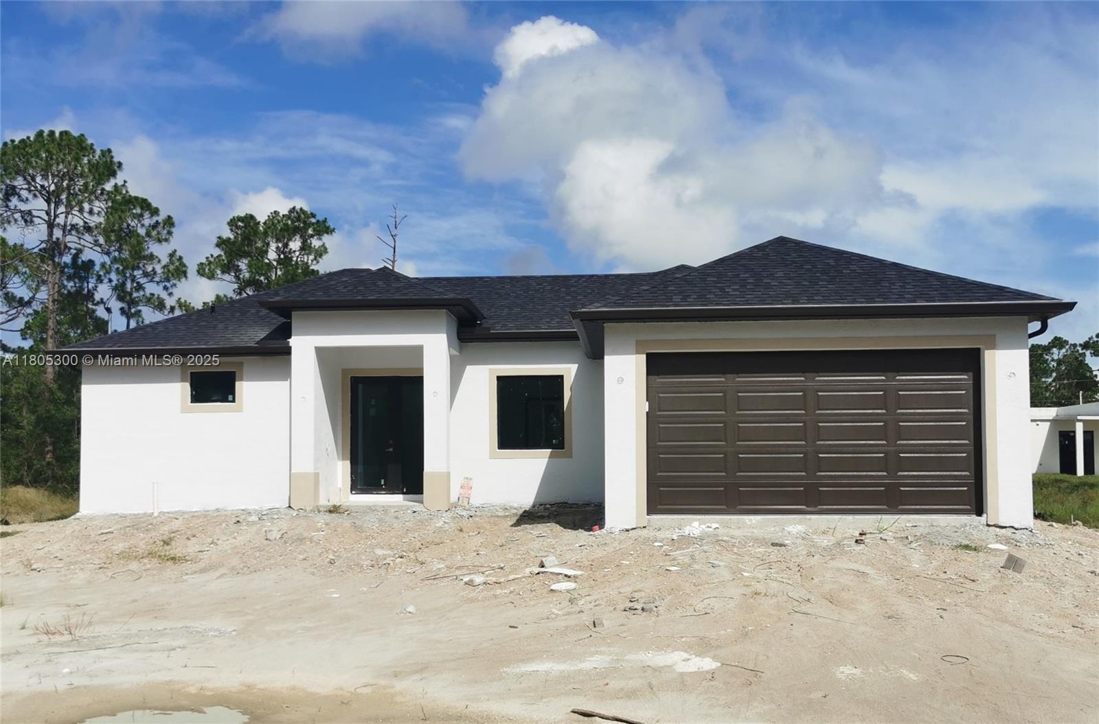 JUST REDUCED! Don't miss out on this COMING SOON beautiful 3-bedroom, two-and-a-half bath NEW CONSTRUCTION residence in the fast-growing area of Lehigh Acres in Florida. With impact windows and doors to ensure safety and durability, while tile floors provide easy maintenance and longevity. A brand new set of stainless steel appliances. All bedrooms have walk-in closets and an indoor utility room for more convenience. The paved driveway leads to a spacious two-car garage, offering ample storage and parking space. The open-concept layout creates an airy ambiance, perfect for enjoying family time. Located in a prime area near State Road 82, just a 15-minute drive from Fort Myers. Don't miss the opportunity to make this exceptional property your forever home! Call Now...Hablo Español.