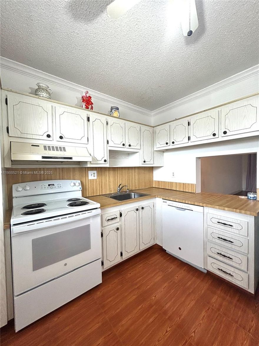 Welcome to this bright, freshly painted, and clean 2-bedroom, 2-bathroom condo located in a 55+ community of Water Bridge. Impact windows throughout!  This charming unit is in great condition and move-in ready, offering a blank canvas to add your personal touches over time. The split floor plan provides privacy, with each bedroom featuring ample closet space. The kitchen is functional and well-maintained. Newer stove and dishwasher. Laminate and tile floors. New custains. Enjoy quiet mornings or peaceful evenings on your private enclosed balcony with a beautiful garden view. The building offers elevator access, laundry facilities, extra storage, and assigned parking. This is a great opportunity for someone looking for a comfortable and affordable home.