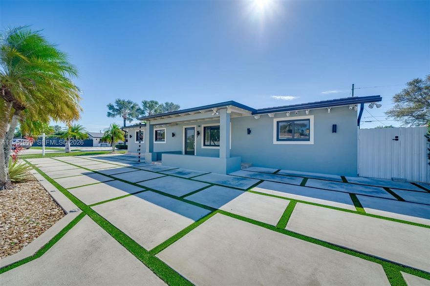 Step into luxury in this impeccably designed four-bedroom, four-bathroom home, perfectly positioned on an expansive 8,065 square-foot corner lot. Thoughtfully upgraded from top to bottom, this residence offers a seamless blend of elegance, comfort, and modern convenience—ideal for today’s discerning buyer.

Enjoy peace of mind with an updated flat tile roof and full impact windows and doors, while high-end designer lighting and premium switches elevate every space inside and out. Sleek porcelain floors lead you through bright, open interiors featuring a stylish wet bar with dual coolers, and a modern kitchen outfitted with striking black stainless steel appliances.

All bathrooms have been fully remodeled with sophisticated finishes. Designed for effortless indoor-outdoor living, the expansive terrace opens to a resort-style heated pool, gourmet outdoor kitchen covered by an ultra modern pergola, and a private cabana bath—perfect for entertaining or relaxing year-round.

Additional highlights include a gas generator for uninterrupted power, an electric vehicle charging station, and an electric side gate that gives you access to store your RV or boat. This exceptional property delivers elevated living, modern efficiency, and timeless style in one unforgettable package. A MUST SEE!!