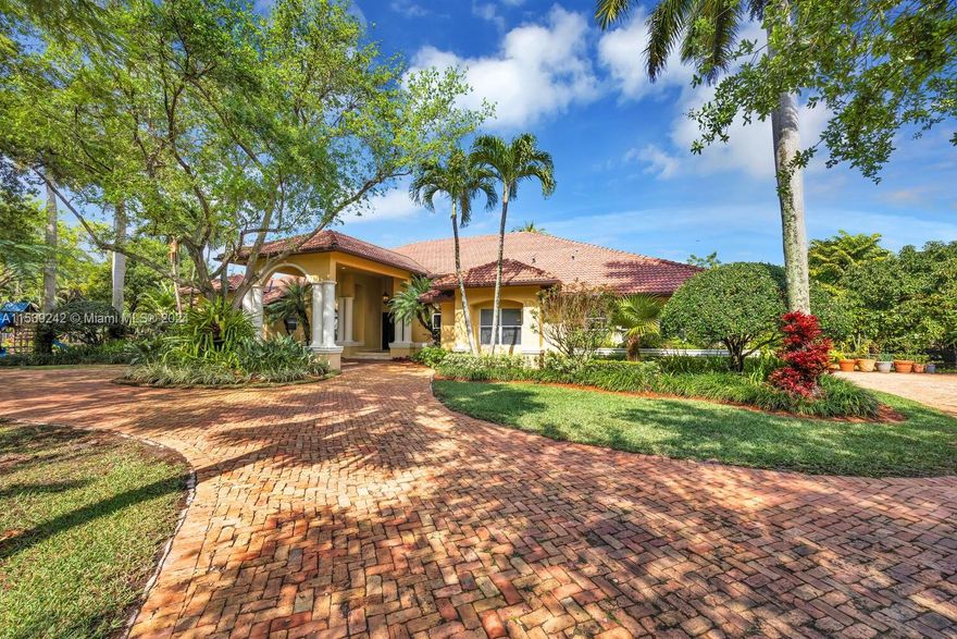 Majestic Luxury Gated Estate on an acre lot, in a quiet cul de sac.  This Stunning Estate features 5 Bedrooms 5 Bathrooms plus library/den, 14ft. ceilings, custom swimming pool complete with a lounge pool, jacuzzi, and Gazebo.  Marble floors throughout, formal dining room, wet bar, huge kitchen and wide open spaces.  Enormous owner's suite complete with his and hers vanity, and private water closet.  The grounds are home to an exquisite collection of mature trees meticulously cultivated.