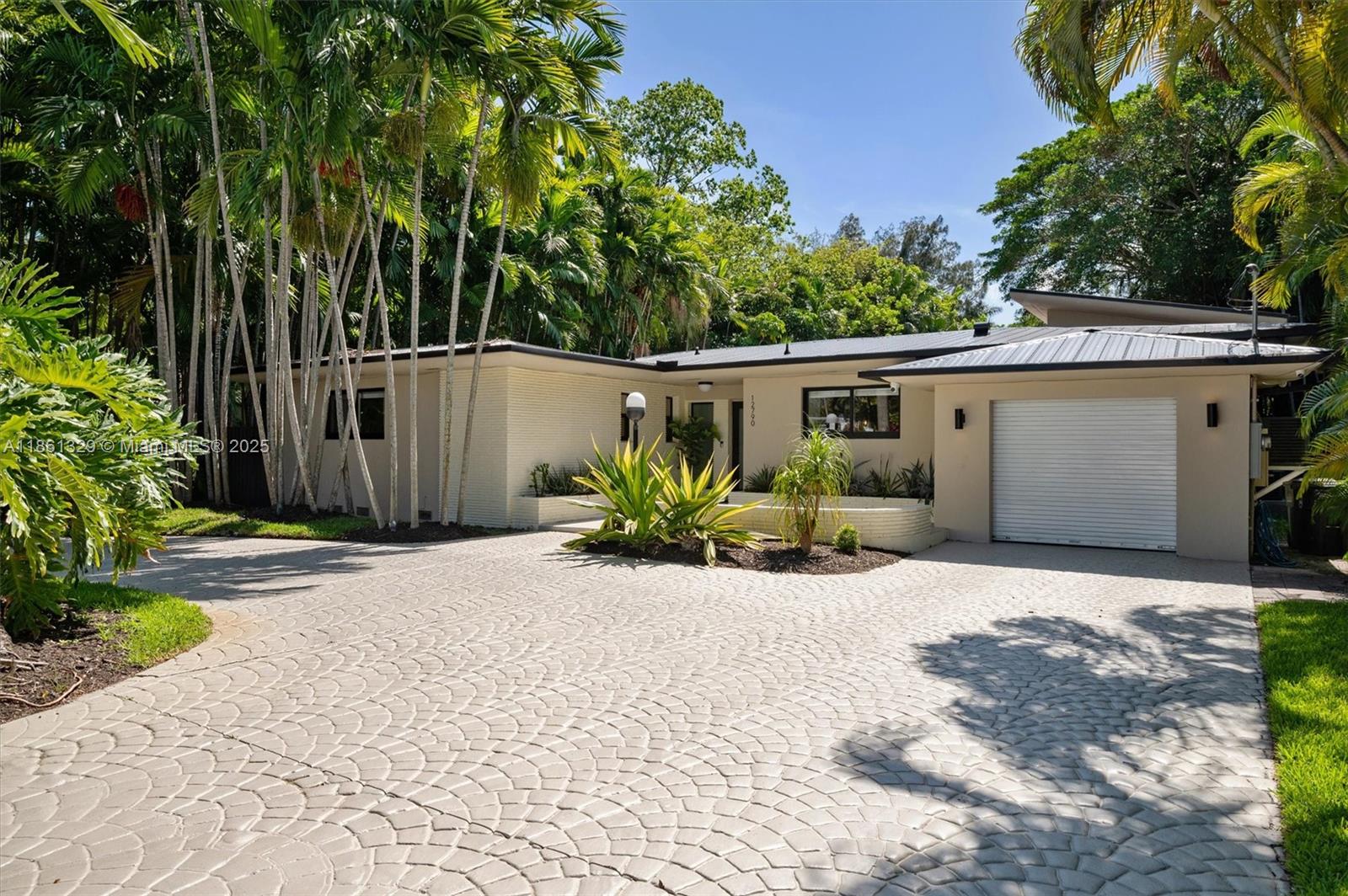 Stunning fully renovated 4 bed, 3 bath + office waterfront home on a lush 0.38-acre lot in prime Biscayne Park! Enjoy 2,906 SQFT of luxury with new hardwood floors, spa-like master wing, walk-in closet, dual ACs, new water heater, and metal roof. Entertain in style with a gas-heated pool, screened patio, outdoor kitchen, lush landscaping, and a full wet bar with commercial wine fridge and ice maker. Upgrades include new plumbing, electrical panel, Tesla/EV charger, and mosquito magician sprinkler. Minutes away to top schools, Whole Foods, Publix, parks, golf, and new rec center!