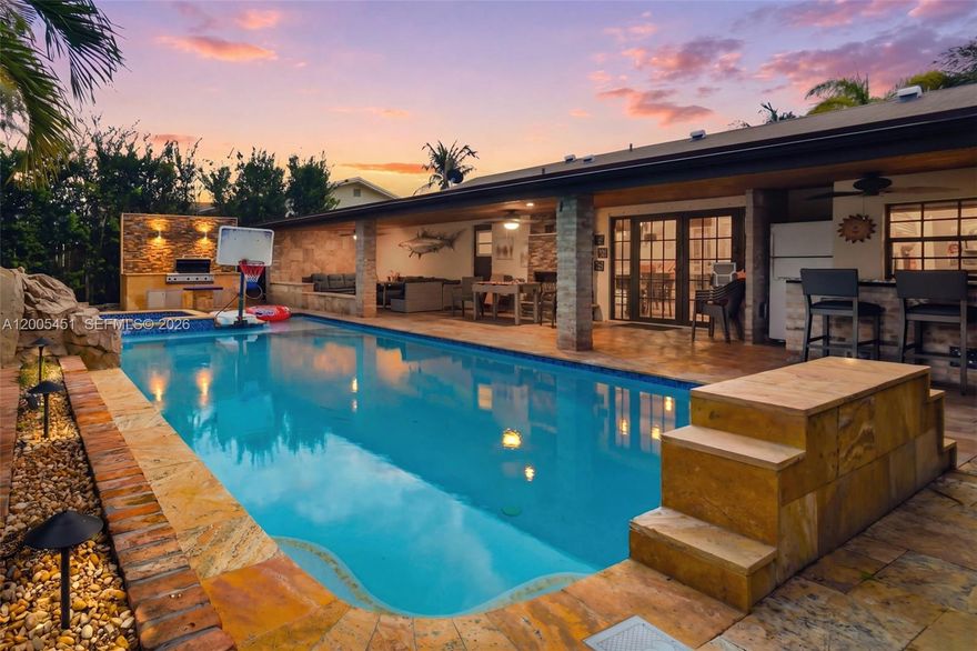 $150,000 IN UPGRADES IN BACKYARD ALONE! Discover this stunning 4-bed, 2-bath home, designed to bring your outdoor living dreams to life. The expansive, covered patio is perfect for year-round entertaining, featuring a cozy fireplace, bar seating, and a unique pass-through window to the kitchen, making it easy to serve drinks and snacks while keeping the party going. Take a dip in the gorgeous heated saltwater pool or relax in the built-in spa, now enhanced with a brand-new smart pool system (Aqualink, 2026), upgraded lighting, and a newer pool heater (2024) that ensures comfort and convenience no matter the season. Fire up the built-in grill for al fresco dining, and as the sun sets, gather around the firepit for cozy evenings under the stars. Inside, the home offers a comfortable and functional layout with thoughtful updates, including a remodeled bathroom (2026), new refrigerator, dishwasher, garbage disposal, and upgraded lighting throughout. With a newer roof (2022/2023) and AC system (2018), plus a spacious garage, this home is built for convenience and designed for endless outdoor fun.