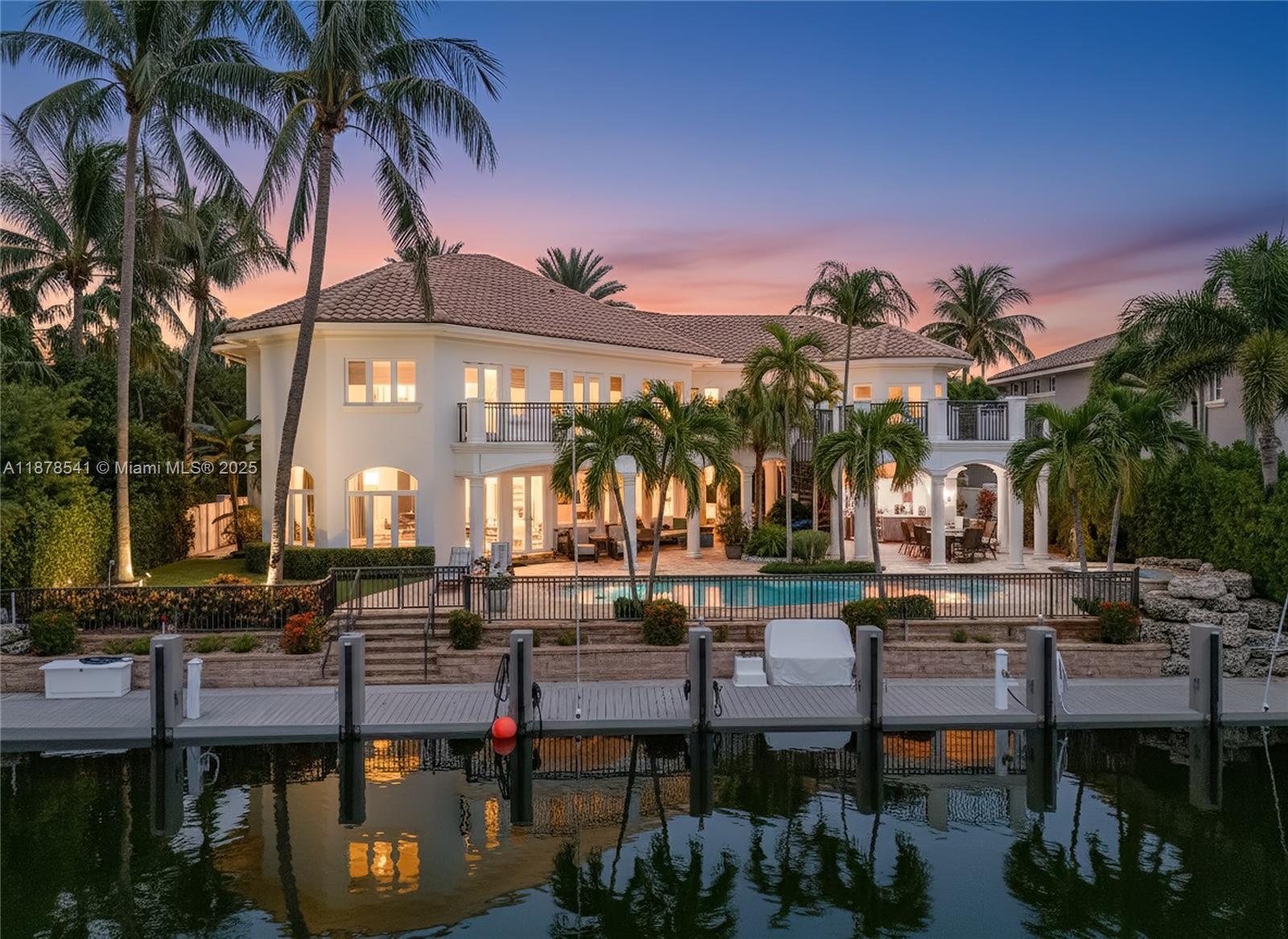 A Mediterranean-inspired masterpiece, this waterfront estate marries timeless architectural grandeur with modern sophistication along 98 feet of deep-water frontage. The grand foyer with soaring ceilings opens to a sunlit great room framed by sweeping water views. The chef’s kitchen, newly updated with oversized island and professional gas range, is a true centerpiece. Two primary suites—upstairs and down—offer spa-inspired marble baths and custom walk-in closets. Additional highlights include a mahogany office, three ice makers, dishwashers upstairs and down, an entertainment lounge with wet bar, sauna, heated saltwater pool, and new dock with 12K-lb davit. A Crestron smart home system, dual laundry rooms, back staircase, 65KW generator, and 3-car garage complete this residence.