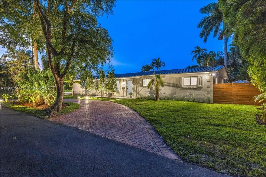 Welcome to the Mid-Mod Ranch in beautiful Biscayne Park! Peaceful, modern, simplicity awaits you in this smartlyupdated three + bed, two bath, sprawling midcentury modern home, nestled between lush medians and picture perfect canopy trees in an idyllic park-like setting. Great features throughout: a welcoming front porch; expansive open-flow living; bright dining; spacious double island kitchen; three privately stacked bedrooms, including the dreamy principal ensuite retreat with large walk-in closet; an extra “flex room” pocket wing perfect as guest nest, office, gym, play room, or zen den; covered rear entertainment patio; new metal roof; impact windows; lush landscaping; an enclosed, attached two car garage; and parking galore. All in a fantastic location in the heart of “The Park.