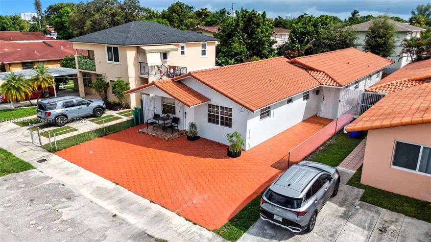 Exceptional investment opportunity two blocks east of Coral Gables! This updated duplex blends modern efficiency with stability. Exterior highlights: a large driveway offering ample parking, barrel tile roof, impact windows and doors, inviting outdoor spaces—a spacious wraparound patio with covered porch, storage and washtub for the rear unit; a private patio for the front. Inside, both units feature consistent tile flooring, granite kitchens with stainless steel appliances, private washer/dryer, contemporary baths, individual water heaters & central AC units. The property consists of a 2/1 and 3/2, both rented to reliable tenants through summer 2026, ensuring immediate income & zero vacancy concerns. Prime location + quality upgrades + steady cash flow = standout addition to any portfolio