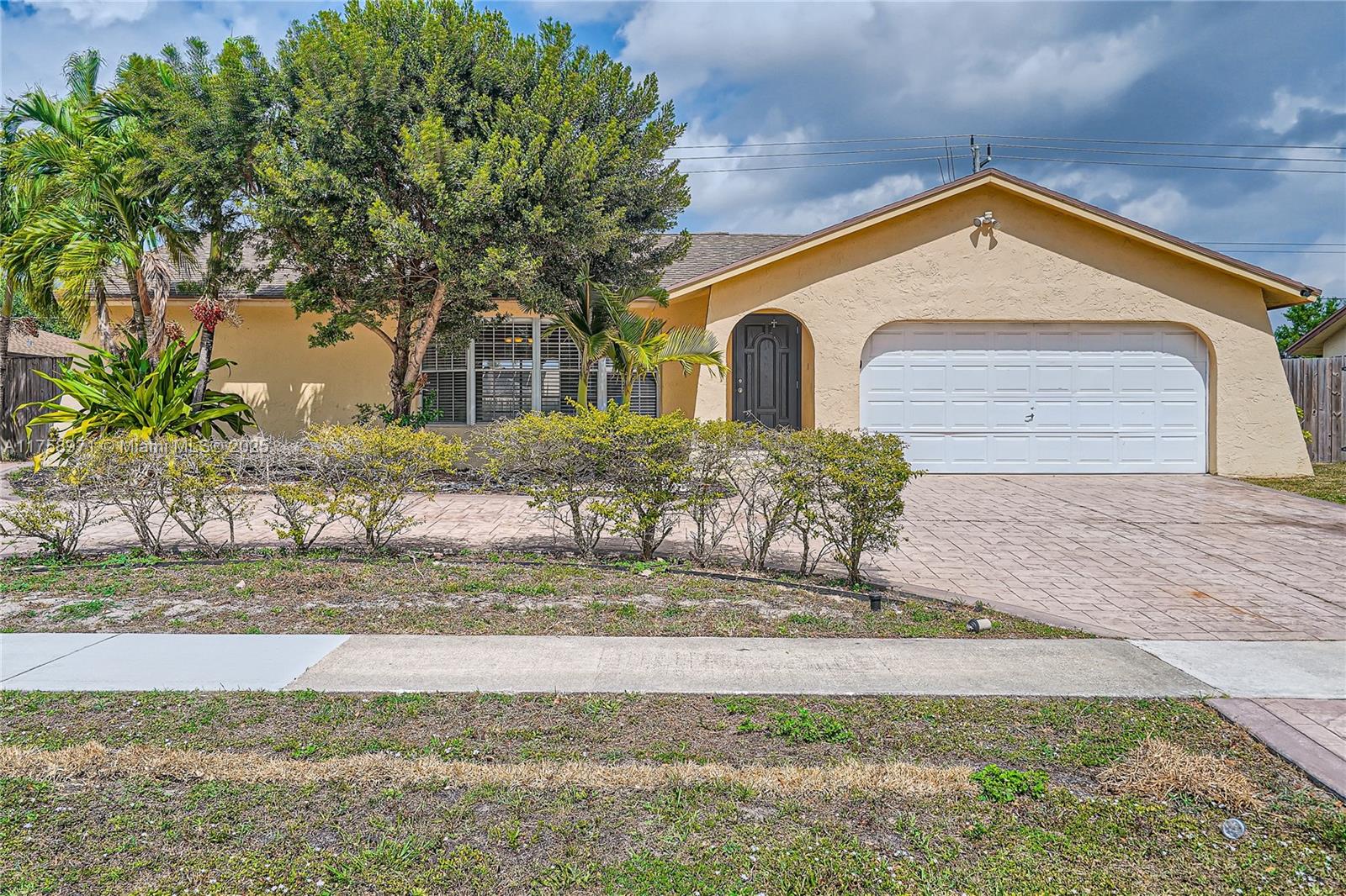 This 4-bedroom, 2-bathroom single-story home is full of potential and ready for your personal touch! Featuring tile floors throughout, this home offers a solid foundation with great bones. The spacious living areas flow into the kitchen and dining spaces, creating an inviting atmosphere for gatherings. Step outside to enjoy the screened-in patio overlooking the private, fenced backyard and sparkling pool—a perfect retreat for outdoor relaxation and entertaining. With a 2-car garage and plenty of storage space. While it does need a little TLC and repairs, it presents an excellent opportunity for investors or homeowners looking to customize their dream home. Don’t miss this chance to add value and make this home truly shine—schedule your showing today!