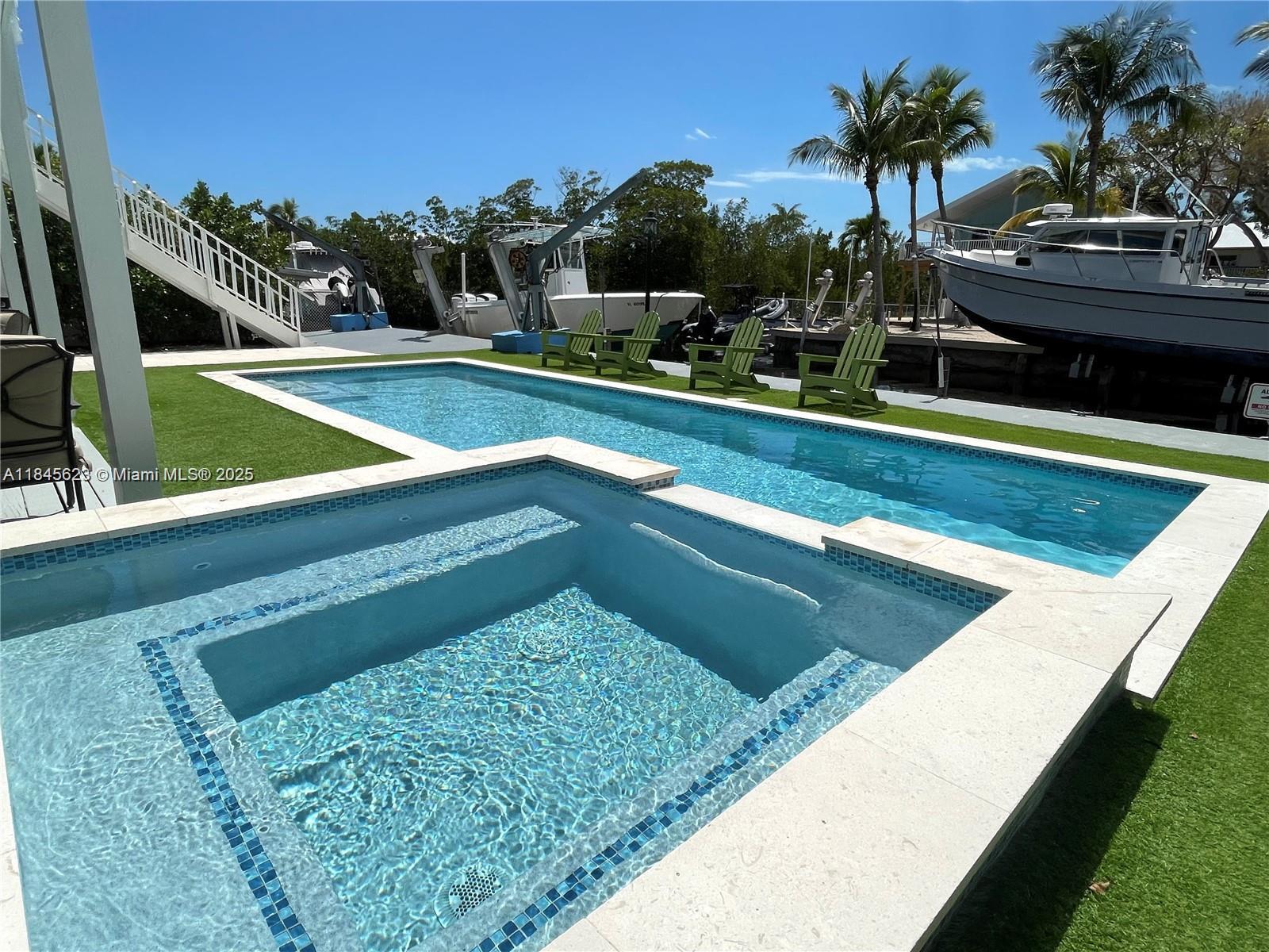 Breath taking house in Key Largo 4 bedroom 3 1/2 bathroom water front. House features stainless steel appliances, cooking island, wall oven and microwave, laundry room . Master bedroom has its own balcony. Exterior features a 75 feet concrete sea wall with a boat lift ,pool , fire pit and plenty of front space to park RV, boat and cars .
