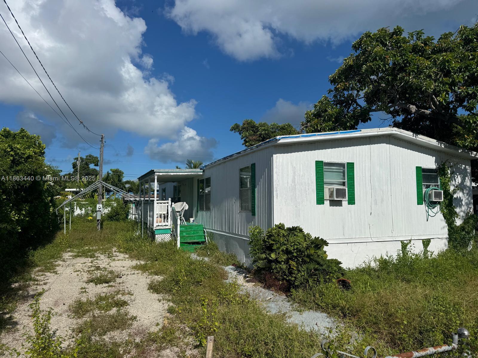 Opportunity awaits in Key Largo! This property is being sold as-is with the existing trailer in place, but the true value lies in the buildable lot. Offering a blank canvas, it’s the perfect chance to design and construct your dream home in the Florida Keys. Nestled in a desirable neighborhood, you’ll be just minutes from marinas, dining, and all the outdoor adventures Key Largo is famous for. Whether you’re seeking a personal retreat or an investment project, this lot is ready for your vision.
