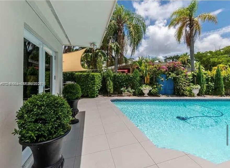 Prime development opportunity in prestigious gated Keystone Point!
This spacious 3-bedroom, 3-bath pool home sits on an oversized 10,300 SF corner lot in one of North Miami’s most desirable redevelopment areas, surrounded by high-end new construction.

The property features a split floor plan with vaulted ceilings, impact windows and doors, a modern kitchen with quartz countertops and stainless steel appliances, engineered wood flooring, and a flexible den easily convertible into a 4th bedroom or office.

The home is tenant-occupied with a secured lease from 02/01/2026 to 01/31/2027 at $5,800/month, providing stable income while plans and permits are prepared — ideal for developers or long-term investors. Cash offers preferred.

Outdoor features include a private heated pool, lush fruit trees, pizza oven, and open patio, offering both immediate rental appeal and strong redevelopment potential. Priced with future improvements or redevelopment in mind.

Prime location just minutes from Bal Harbour, Aventura, beaches, and top-rated schools.