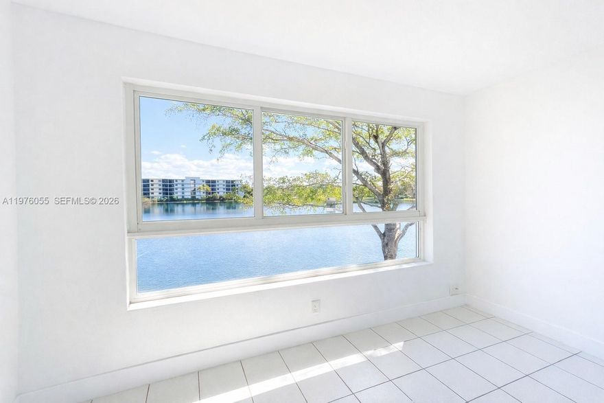 Lakefront unit featuring 2 bedrooms and 2 full bathrooms, including a spacious primary suite with a private bath. The home offers a bright open-layout concept and an additional den—perfect for a home office or flex space—overlooking the lake. Enjoy peace of mind with impact windows and doors throughout. Located on the second floor, the unit includes assigned parking and is situated within a gated community.