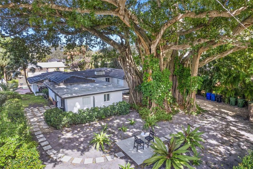 One of the most enchanting homes in the desirable River Oaks community, this unique gem is nestled in a lush tropical locale, featuring a majestic Banyan tree on a spacious double corner lot. The elegantly designed 4-bedroom, 2.5-bath home is ideal for entertaining and boasts a stylish kitchen with a gas range, a coral rock fireplace in the living room & an open layout with views of the serene pool area and tropical surroundings. The living & dining rooms have glass doors opening to the pool and covered patio. The primary suite offers a fireplace, ample walk-in closet & a bathroom with double sinks and shower. Additional features include hurricane windows/doors, skylights & a laundry/storage room. This opportunity is due to seller's international relocation, furniture is negotiable.