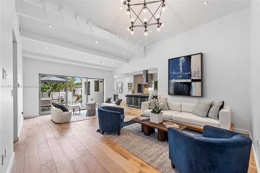 Be the First to Live Here! Best priced home on prestigious Pine Tree drive! This chic modern residence is remodeled & ready for you. After a total gut renovation, this home was completed in 2023 & is equipped with all new electrical, plumbing, impact windows & doors, & A/C. Inside find a spacious open floor-plan w/5BD + den, 4.5BA, sun-filled interiors, high Cathedral ceilings in the great room, wide-plank oak hardwood floors, primary suite w/walk-in closet & gorgeous bathroom, & a custom Italian gas kitchen by Pedini w/quartz backsplash, huge island, & top-of-the-line Miele, Viking, Wolf, & Monogram appliances. Outside enjoy a private fenced backyard w/a heated saltwater pool, summer kitchen w/sink & pizza oven, lush landscaping, & ample parking + plans for garage expansion included.