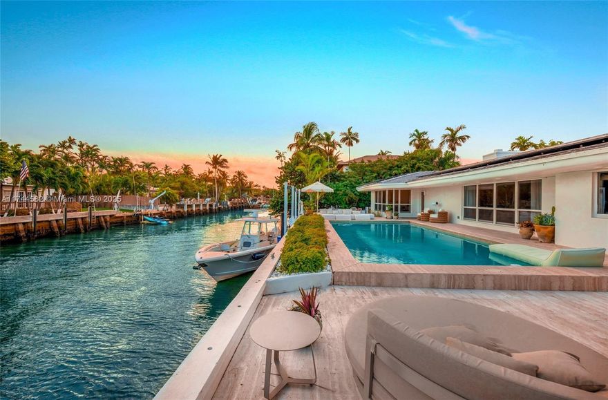 Discover 110 feet of prime waterfront just two houses from the open bay along this exquisite mid-century modern masterpiece. This completely remodeled 5-bedroom, 4.5-bath haven boasts roughly 4000 square feet (bigger than tax roll) of refined elegance. The Amish handmade kitchen, adorned with Italian travertine, is an architectural delight. The home offers a unique Dirty French-inspired movie room, perfect for entertainment. Revel in the lushly landscaped front yard featuring a serene koi pond, while the expansive backyard.  Enjoy the luxury boating access from this oversized 11,258-square-foot lot. Dive into the below-ground pool, or barbecue with friends in your custom barbecue area.This Bayfront treasure is truly unparalleled.