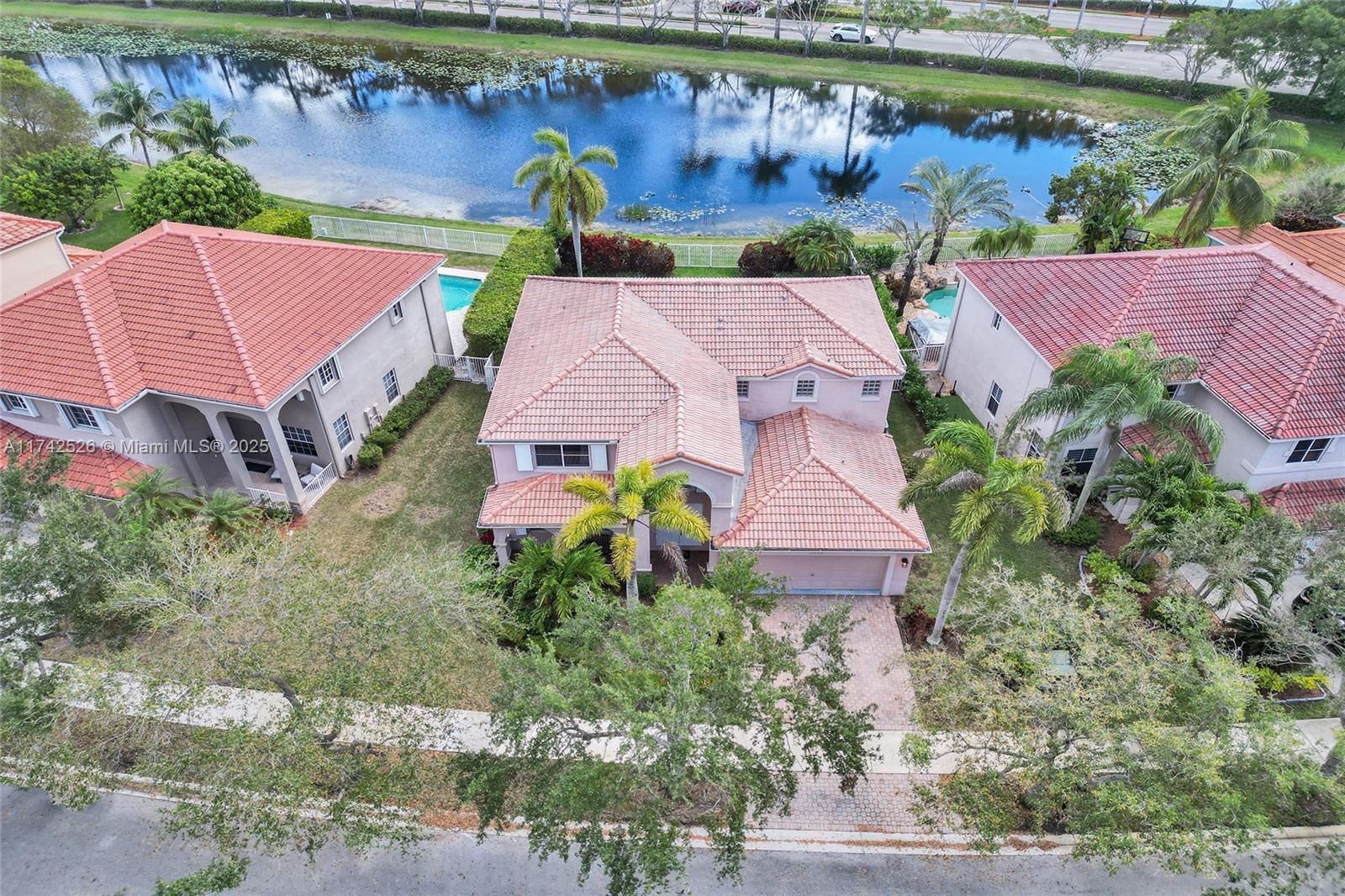 Welcome to your peaceful retreat in The Ridges, one of Weston’s most desirable guard-gated communities. This 5BR/4BA home offers serene lake views, an open floorplan. Start your day in your private backyard with endless water views, and enjoy community perks like scenic trails, green spaces, a renovated pool, and clubhouse. Just minutes from A-rated schools, parks, dining, highways, and beaches. Seller offering $25,000 credit toward roof replacement—the perfect blend of comfort, location, and lifestyle!