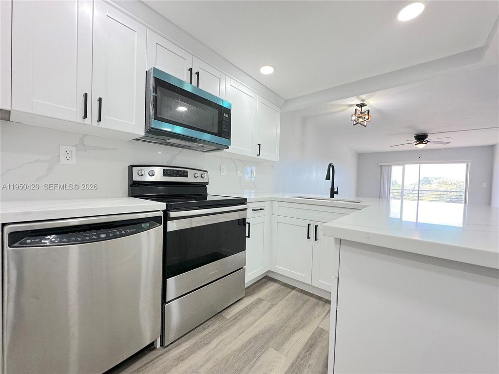 Photo of 3110 N Pine Island Rd #408, Sunrise, FL 33351 (MLS # A11950420)