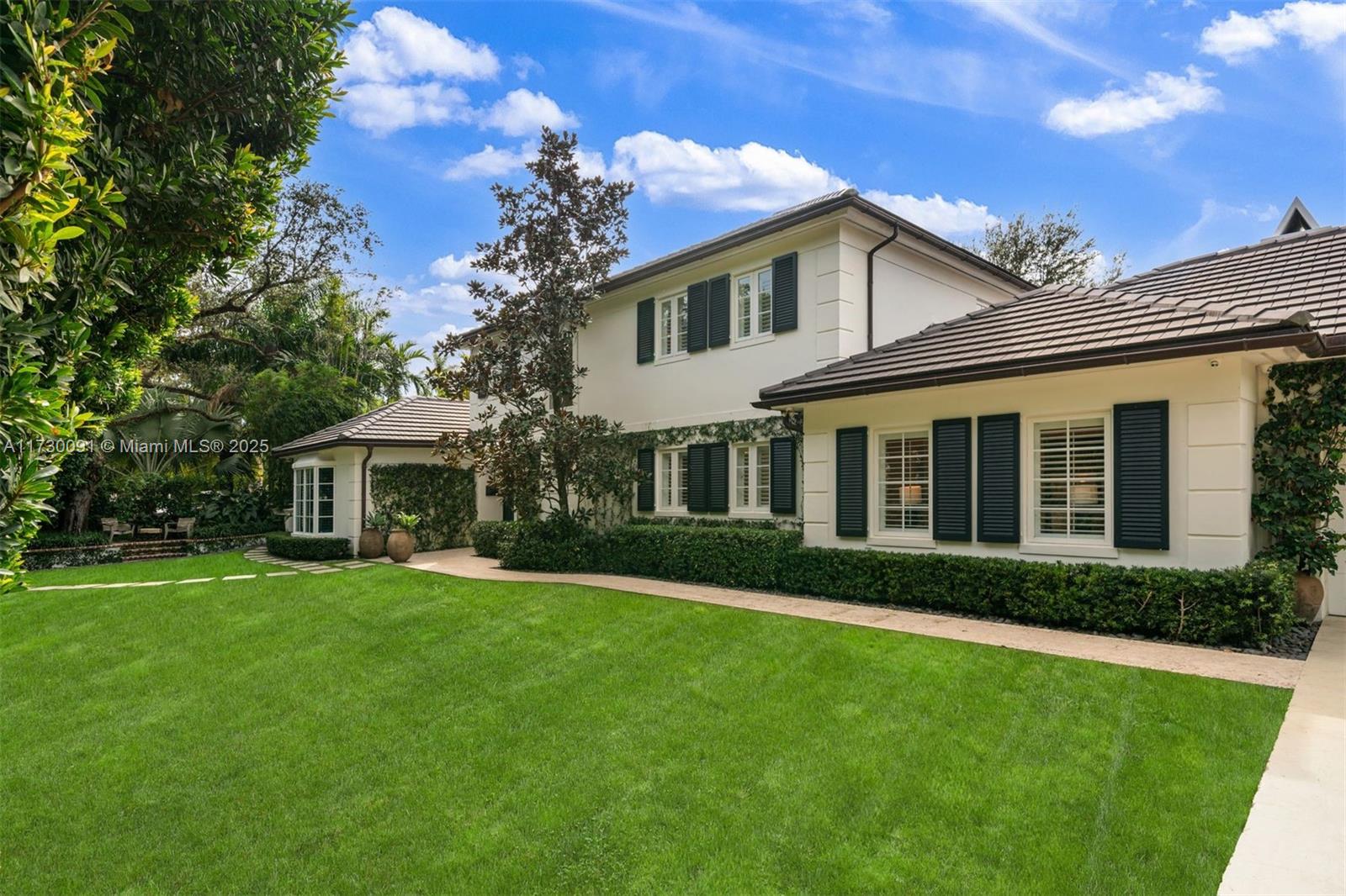Discover this custom built Colonial style home in the highly sought after South Gables on Granada Blvd. The grand two story foyer welcomes you to an exceptional floor plan with ample storage. Enjoy spacious formal living and dining rooms along with a separate family room for both adults and children which all lead to a chefs dream kitchen with a gas stove and eat in area. French doors in the entertaining areas open to a fantastic covered patio, with summer kitchen, overlooking a sparkling pool and putting area. The ground floor features a wonderful primary with walk in closet, office, and guest room. Upstairs are three bedrooms with a two baths and a den. Additional amenities include a two car garage with AC, wine cellar, storage room, cabana bath, and full house generator.