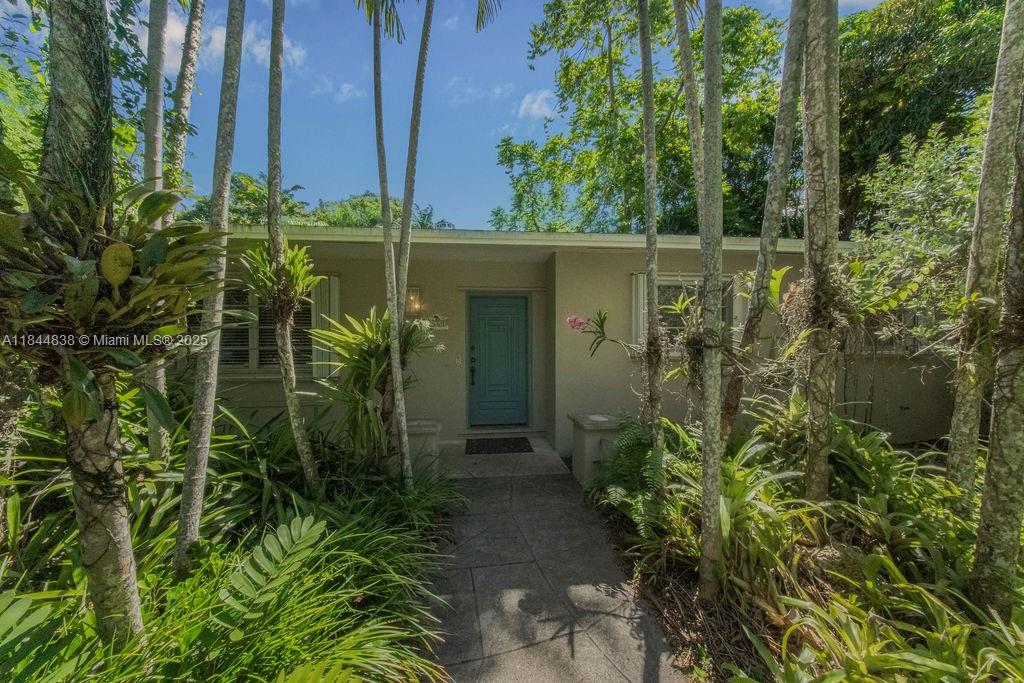 Welcome to this spacious and gorgeous tropical oasis where butterflies abound. This lovely home is surrounded by lush foliage and exotic fruit trees such as lychee, jack fruit, star fruit, mango, and avocado. Huge in-law suite with separate entrance, garage, living area and kitchenette space. Two garages and screened-in back porch to enjoy the private, fenced-in yard. Plenty of space for a big family with 5 bedrooms. Newer roof and central AC's. Loads of storage space. Close to recreation areas and great schools. Make this home your own with some interior updates. Easy to show!