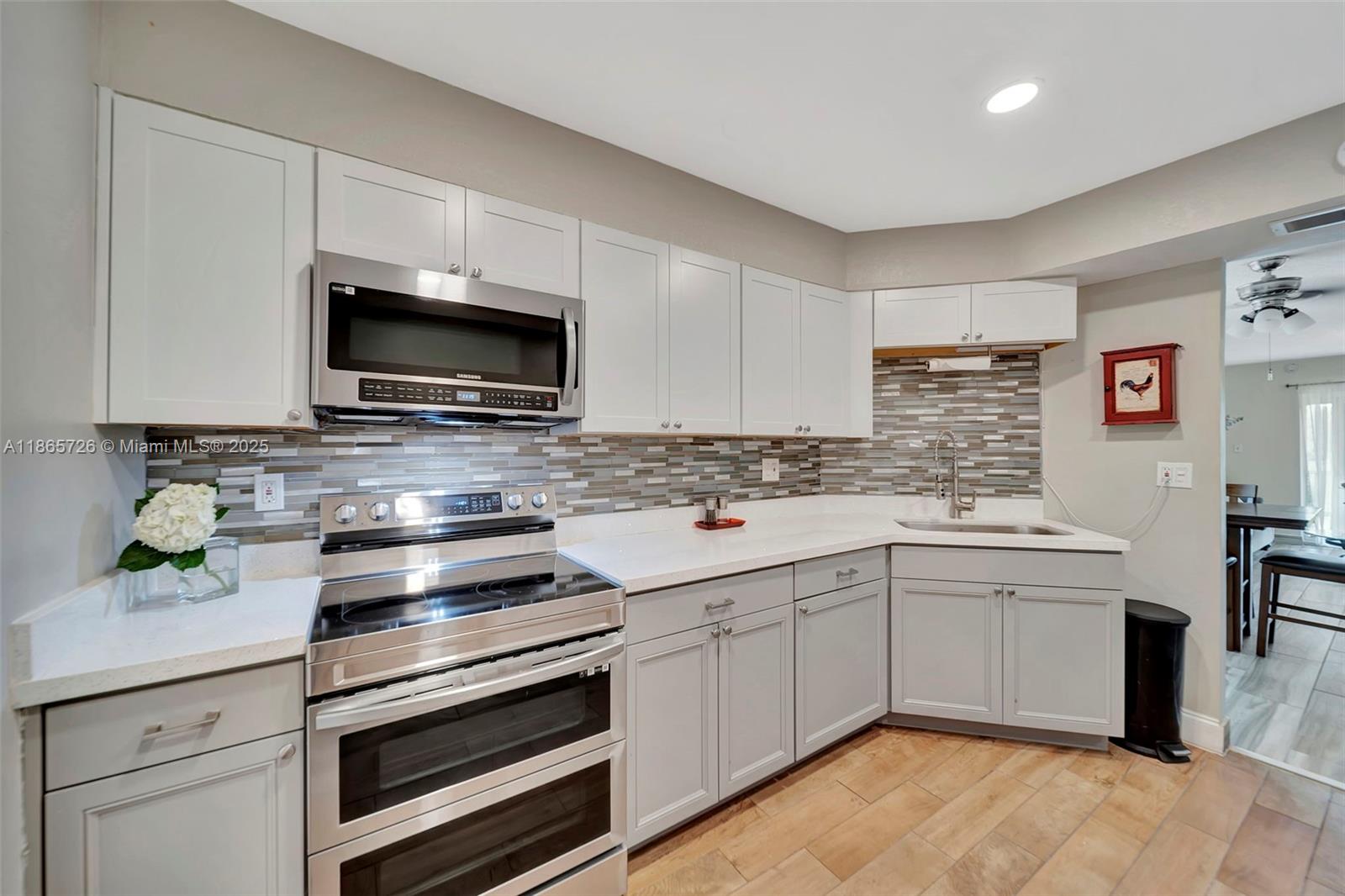 Beautiful 2 bed, 2 bath light bright corner unit condo in Coral Springs! Feels like a single-fam home actually. Located on the 2nd floor (with elevator), this unit features wood-look tile throughout, a newly updated kitchen with quartz countertops and double air fry oven. Bathrooms are also updated with frameless glass enclosures and beautiful modern tile and vanities. Enjoy serene views of oak trees and a canal with water lilies from your screened-in patio. Affordable monthly fee of \$517 includes access to pool and clubhouse. All ages welcome, rentals allowed after 2-year waitlist. Prime location near highways, shopping, dining—walk to Starbucks!